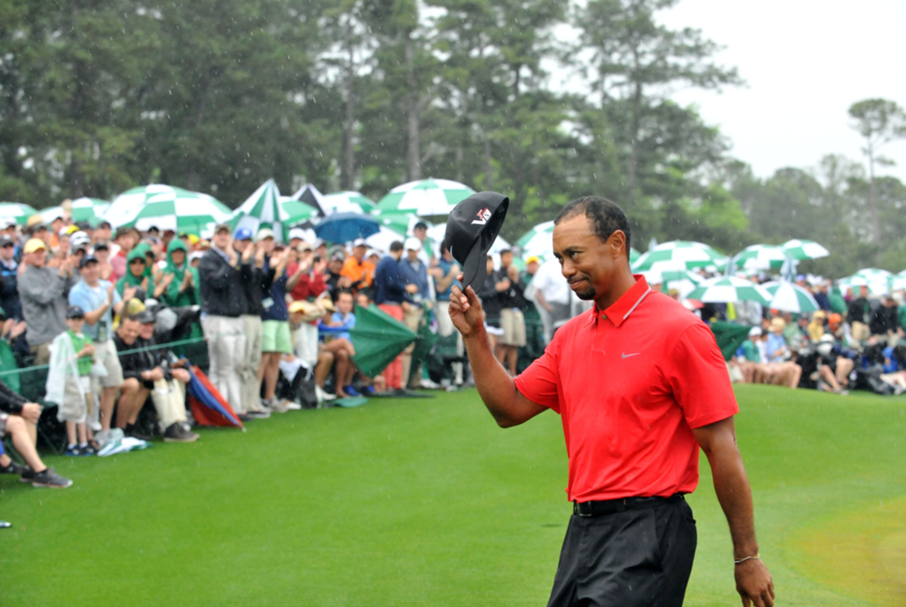 APRIL 14, 2013 AUGUSTA Tiger Woods leaves the #18 green following his play during the final round in the Masters Tournament at Augusta National Golf Club on Sunday April 14 2013. KENT D. JOHNSON / KDJOHNSON@AJC.COM My assignment for the Masters had me editing the photos shot by our staff team. On Sunday, I decided to go out to the 18th green and make some photos while waiting for photos from the lead group, which didn� include Tiger this year. It had been good weather for most of the weekend, but on Sunday, the clouds opened up and I had not brought my raingear. After about an hour in the rain, I finally made it back inside with at least one memorable photo. Made with NIKON D3, 80mm, f/6.3, 1/640 sec, 5000 ISO.