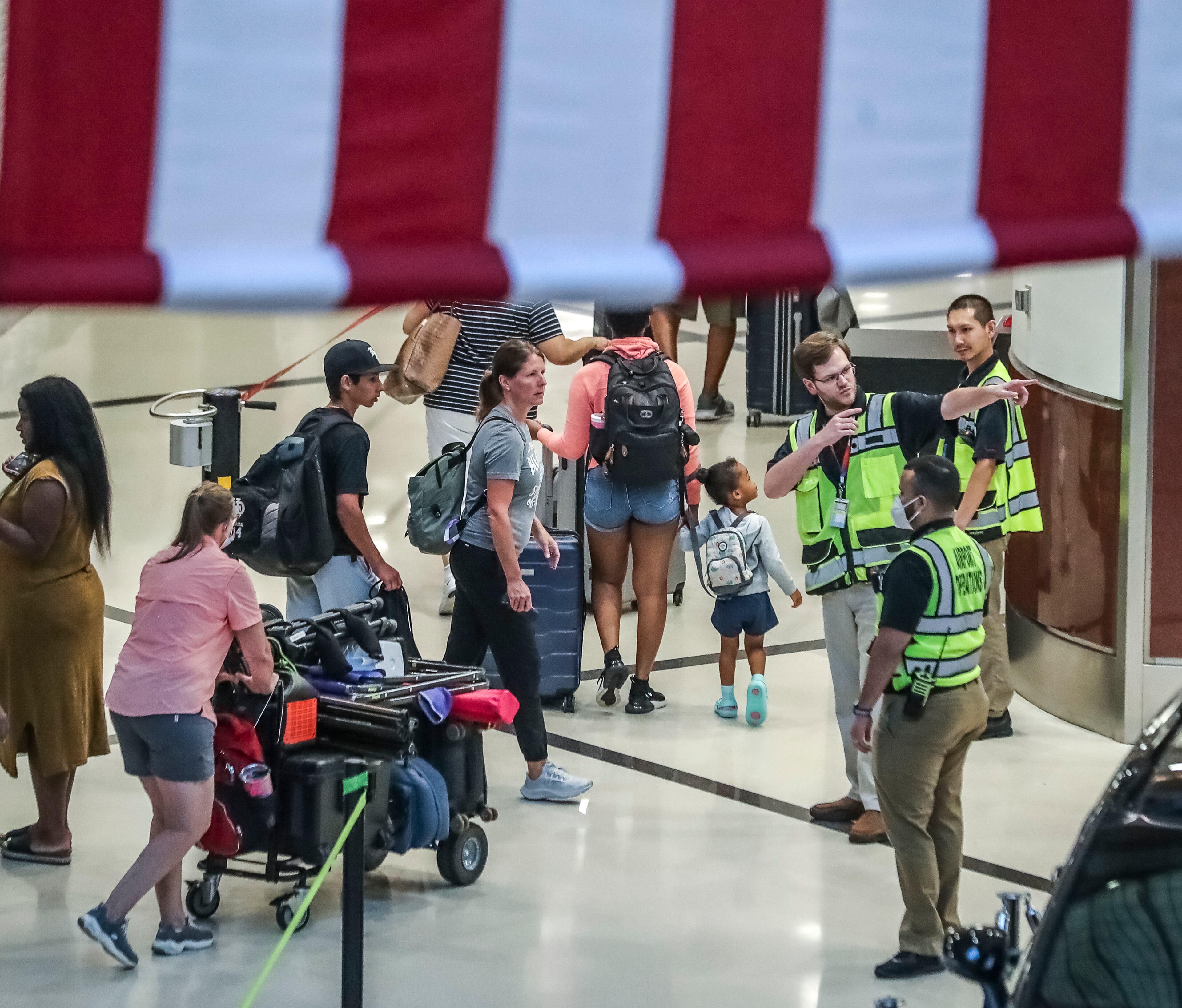 July 5, 2022 Hartsfield-Jackson International Airport: Airline travelers made their way through Hartsfield-Jackson International Airport in the atrium at the domestic terminal on Tuesday, July 5, 2022 after managing through a busy Fourth of July weekend for air travel with storms and cancellations, airlines face the challenge of navigating through the rest of a busy summer. (John Spink / John.Spink@ajc.com)