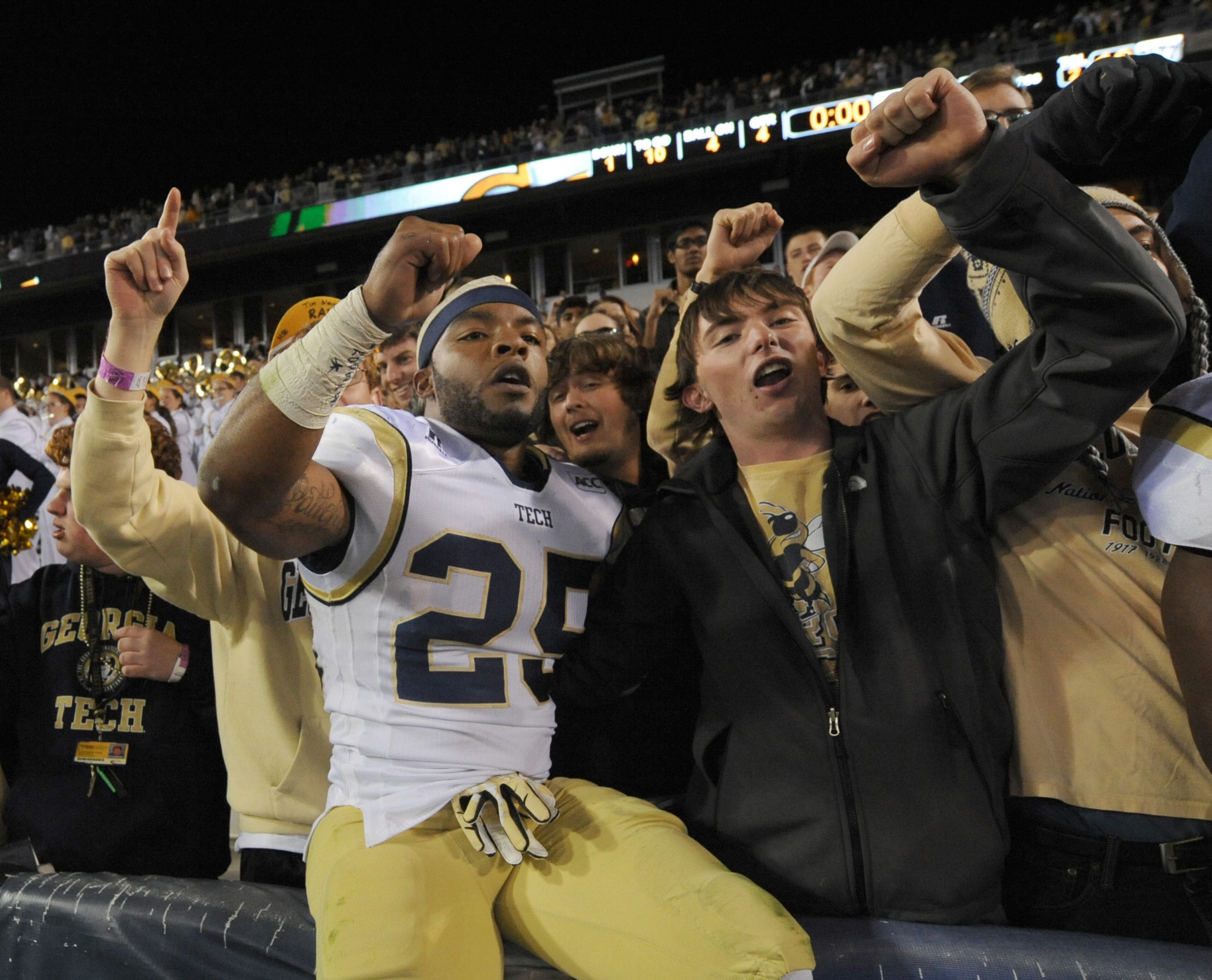 Georgia Tech's Robert Godhigh (25) celebrates a win with Georgia Tech fans.
