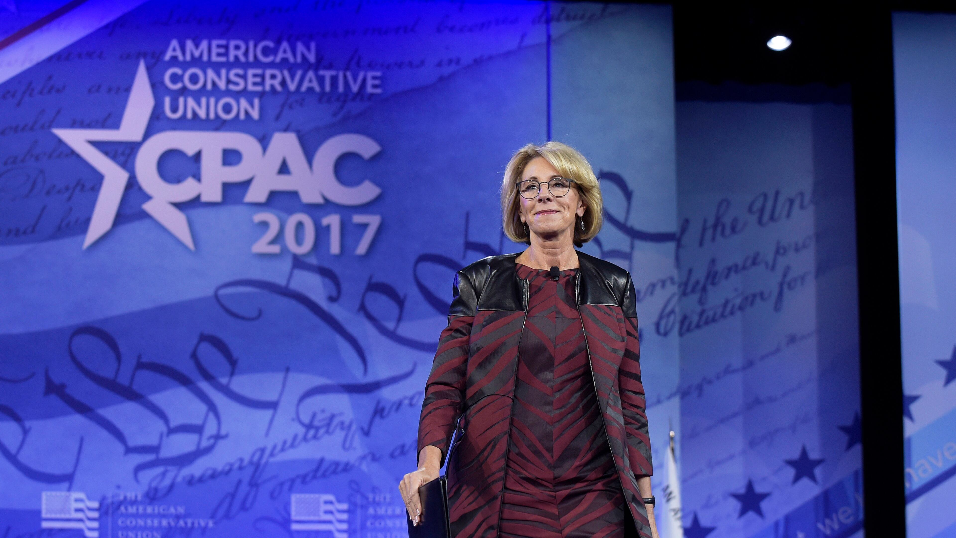 In this Thursday, Feb. 23, 2017 photo, Education Secretary Betsy DeVos arrives to speak at the Conservative Political Action Conference in Oxon Hill, Md. The school choice movement has been cleaved into two camps: those who want to use choice to improve public schools and others, like DeVos, who want to go further by allowing tax money to flow to private schools through vouchers, government-funded scholarships or corporate tax credits. (AP Photo/Susan Walsh)