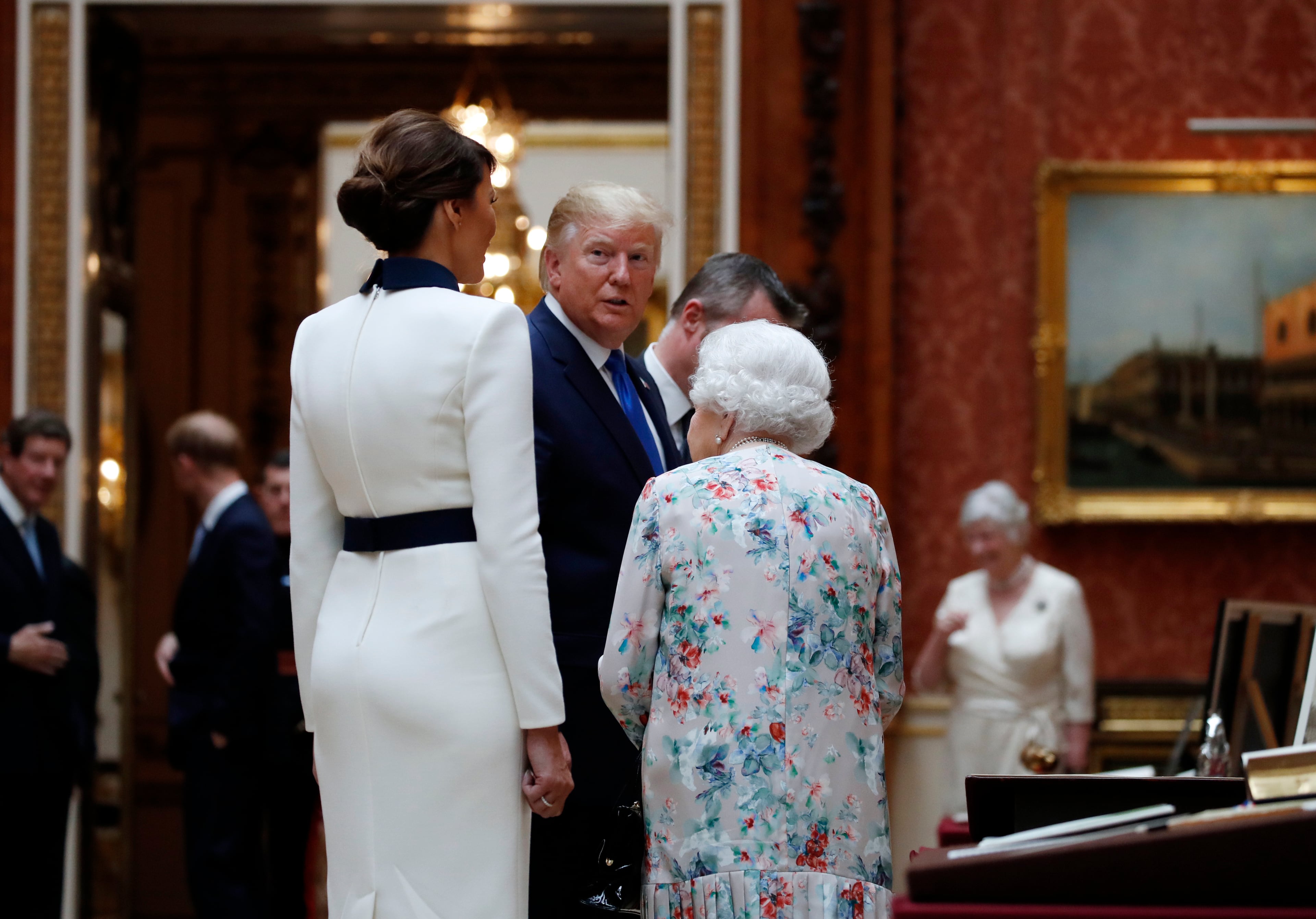 President Donald Trump, first lady Melania Trump and Queen Elizabeth II, walk in the Picture Gallery at Buckingham Palace, Monday, June 3, 2019, in London. (AP Photo/Alex Brandon)