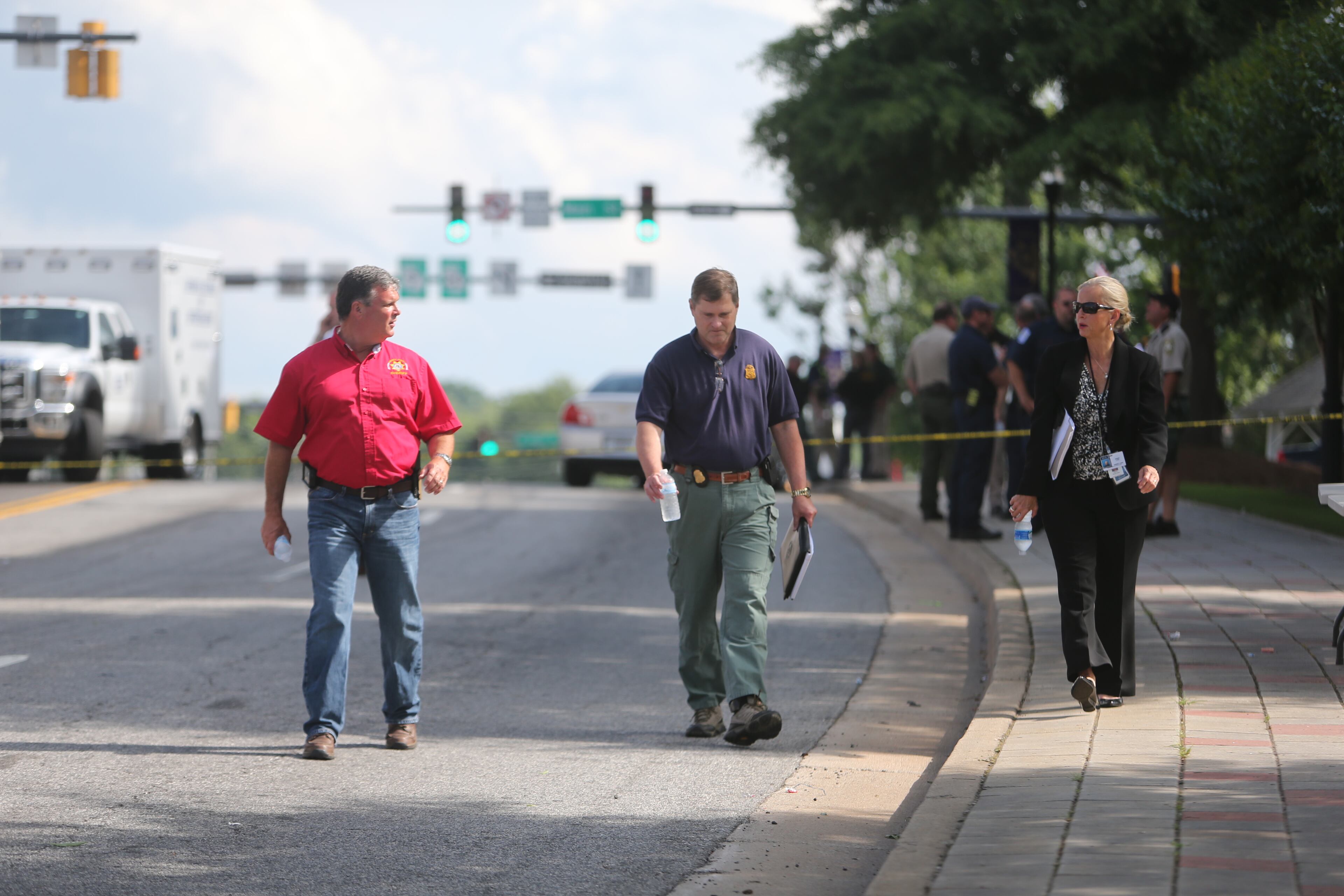 Authorities investigate the scene of shooting that took place in front of the Forsyth County courthouse in Cumming, Ga., on June 6, 2014.