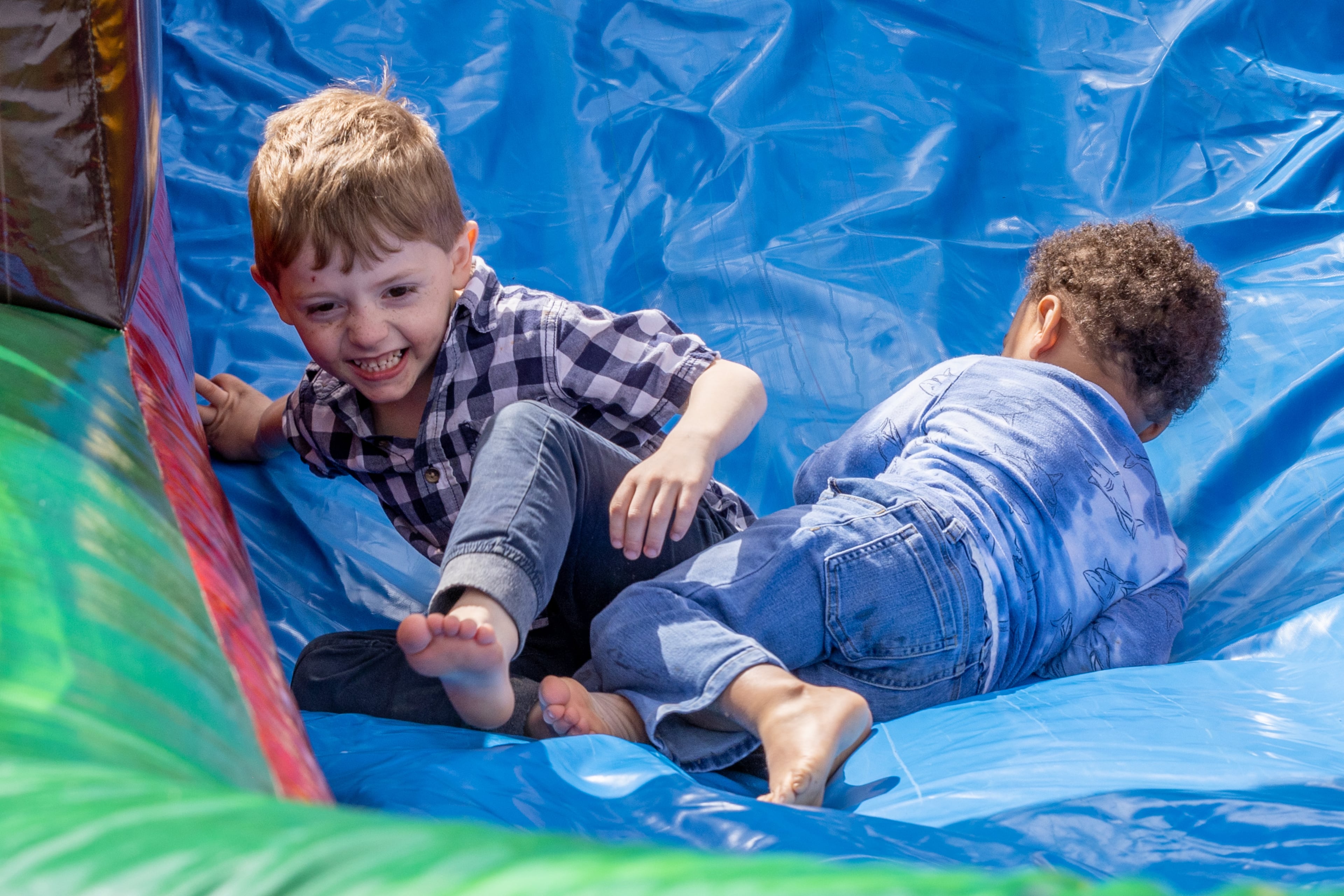 Kids play in the inflatable rides before the start of the Homer Easter Egg Hunt “In Celebration of Mack Garrison" in Homer, Georgia on Saturday, April 1, 2023. The Garrison family started the annual tradition in 1959, which would become known as Georgia's largest Easter egg hunt, with more than 100,000 candy eggs.(Steve Schaefer/steve.schaefer@ajc.com)