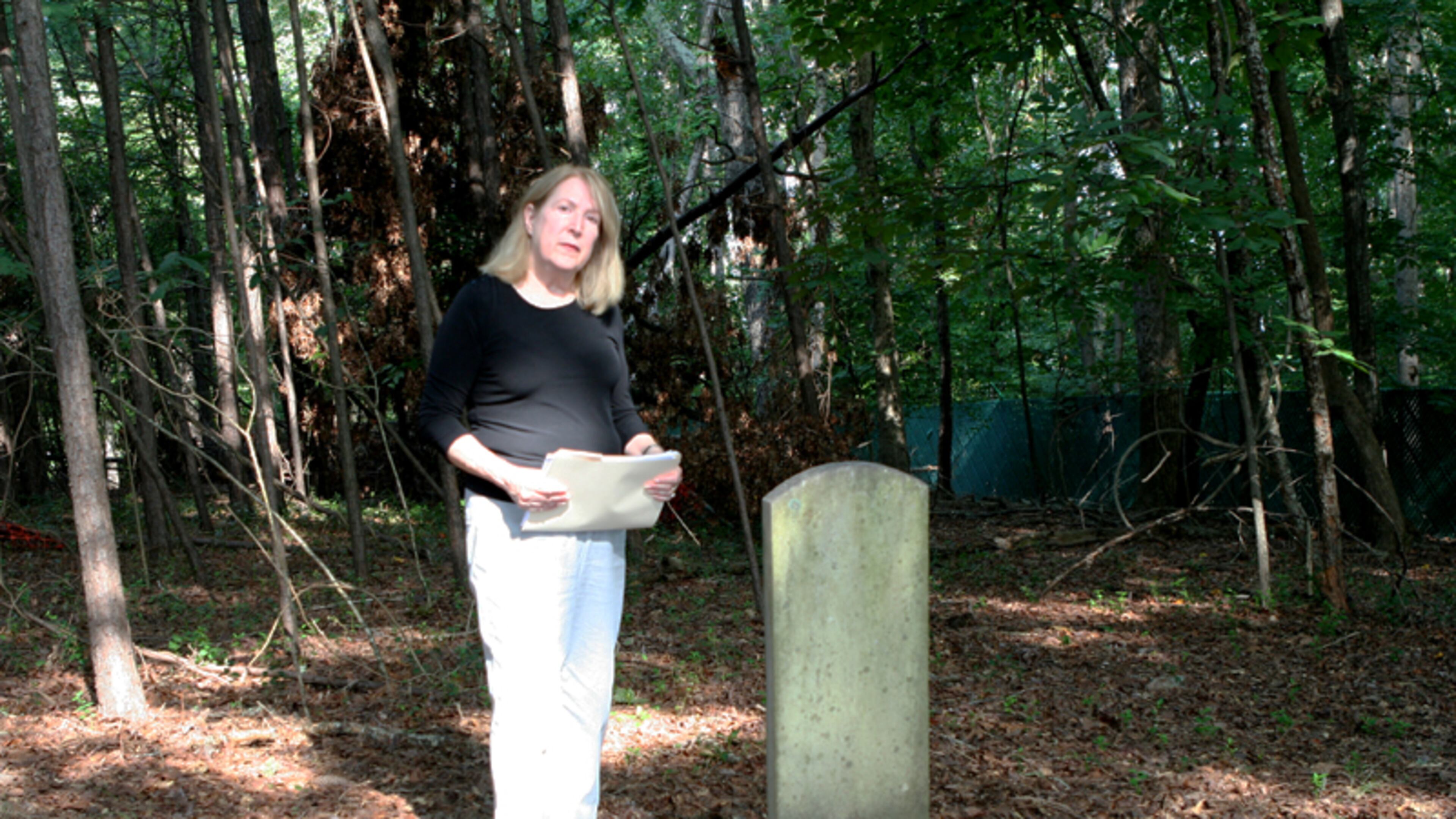 Joan Compton, president of the Johns Creek Historical Society, at the Macedonia African Methodist Church Cemetery in Johns Creek. DAVID IBATA FOR THE AJC