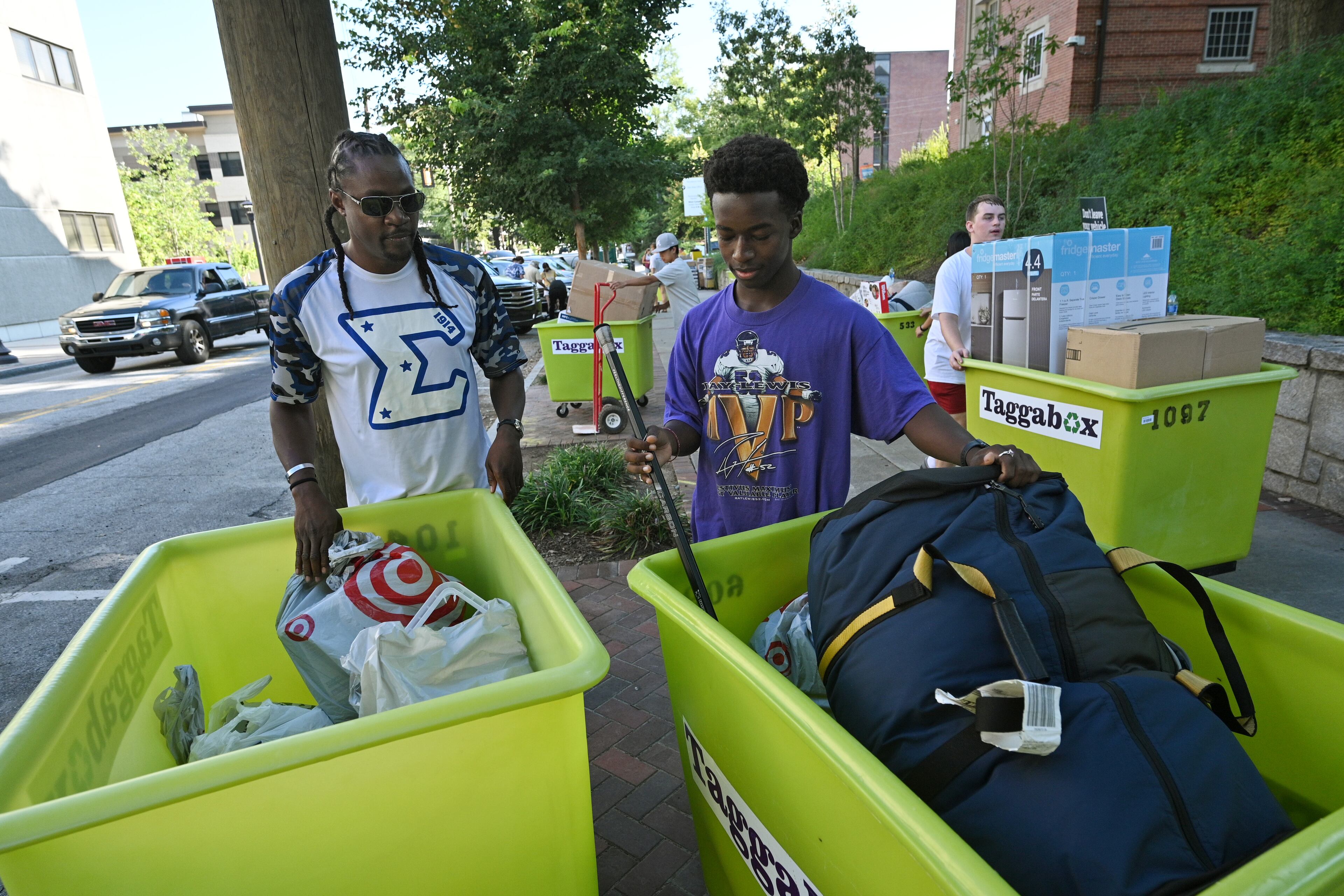 Georgia Tech freshman Aris Williams, with the assistance of Lavan Wright (left), moves into his dormitory for the fall semester on the Georgia Tech campus on on Saturday, August 14, 2021. (Hyosub Shin / Hyosub.Shin@ajc.com)
