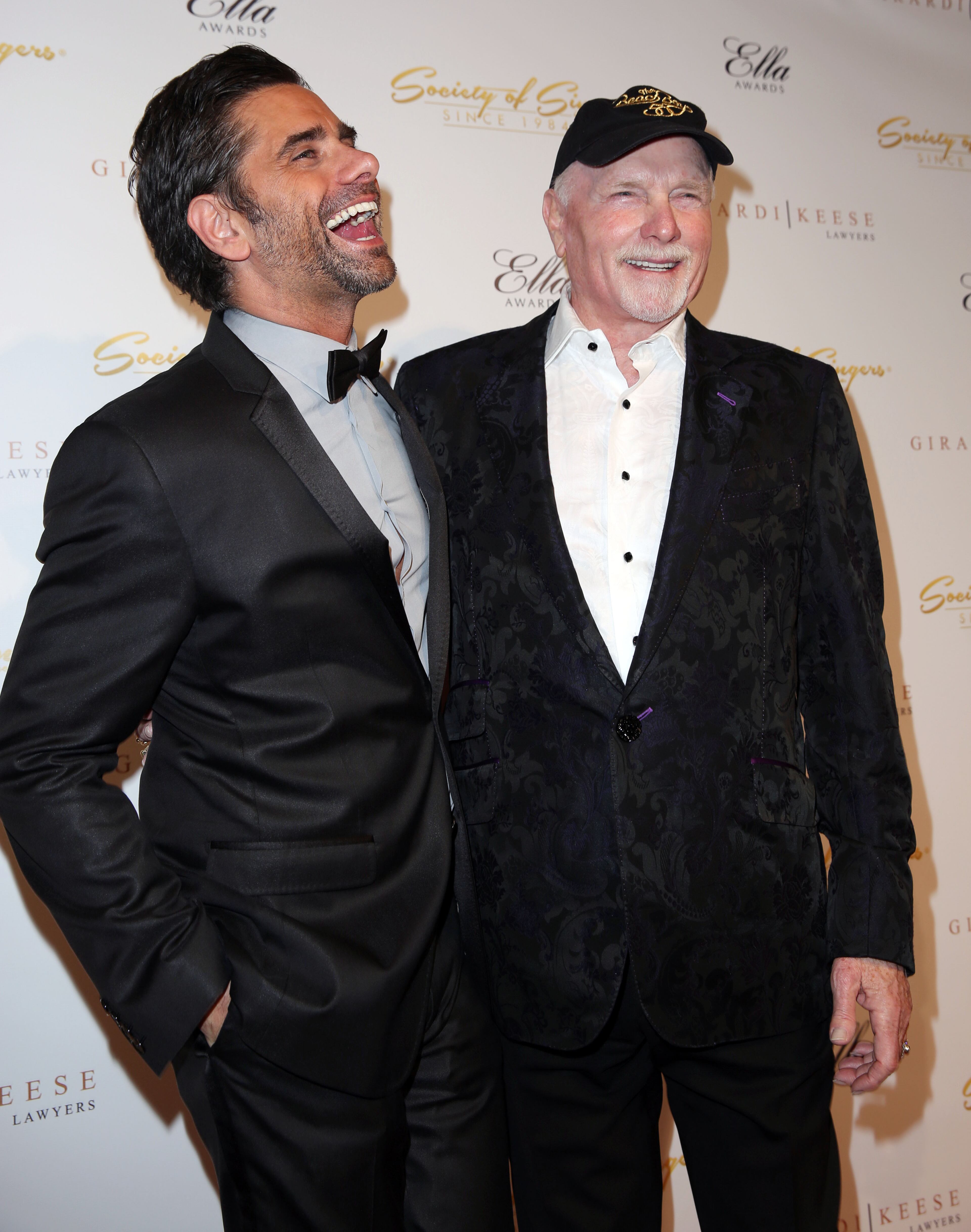 Mike Love, right, and John Stamos pose together at The Society of Singers' 21st ELLA Awards on Thursday, Feb. 20, 2014 in Beverly Hills, Calif. The event honored Mike Love, lead singer and co-founder of The Beach Boys, producer Nigel Lythgoe, and backup singers The Waters Family. (Photo by Matt Sayles/Invision for The Society of Singers/AP Images)