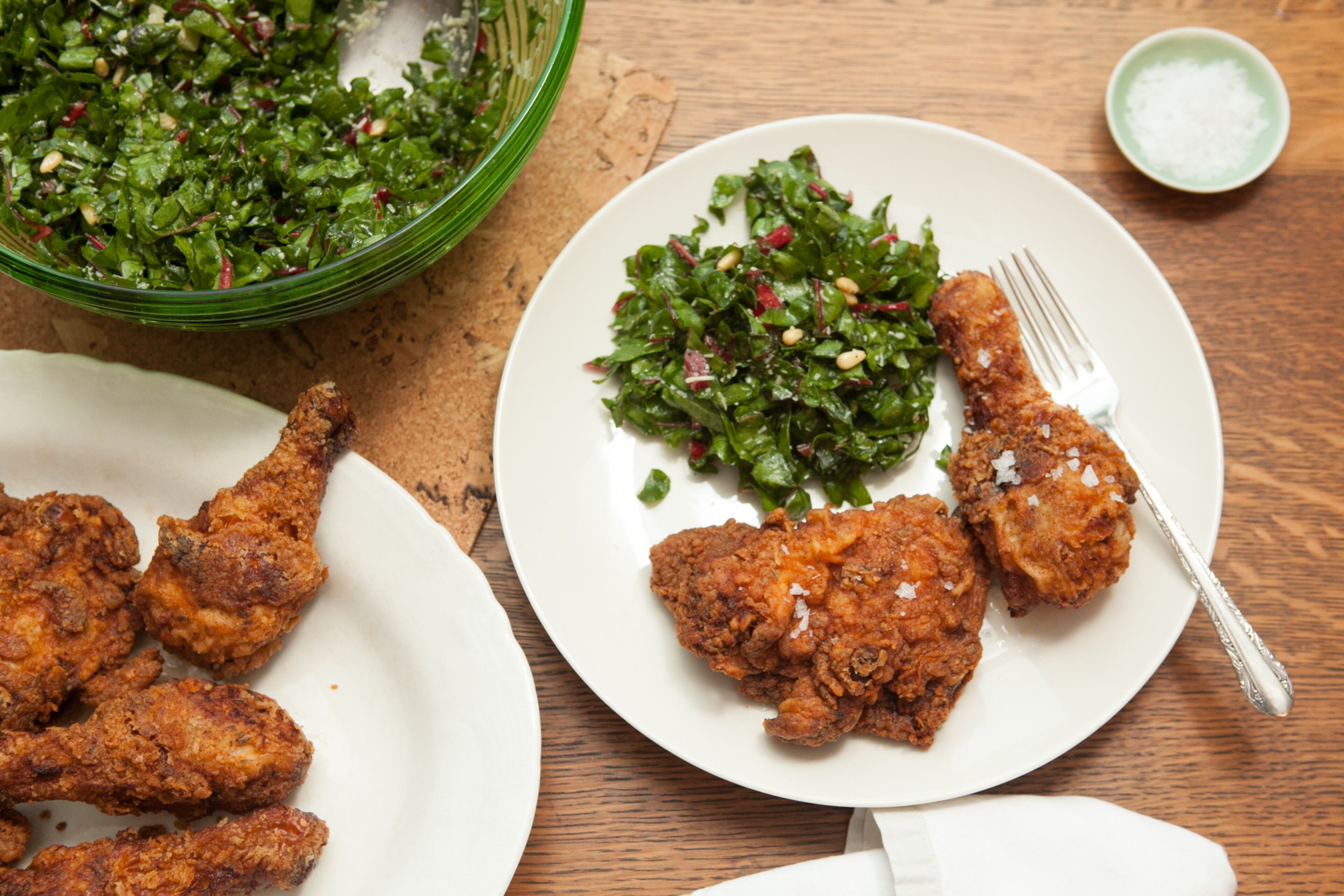 Art Smith's Fried Chicken and Swiss Chard Salad with Pine Nuts and Lemon. The former personal chef of Oprah Winfrey, Southern-born Art Smith fixes chicken like grandma made (marinated in buttermilk and fried in a spicy double crust) and pairs it with a healthy green salad of lemony Swiss chard. Miami-based author Lee Brian Schrager included his friend's recipe in his new book "Fried & True: More Than 50 Recipes for America's Best Fried Chicken and Sides" (Clarkson Potter, $22.50). (styling by Wendell Brock) (Photography by Renee Brock/Special)