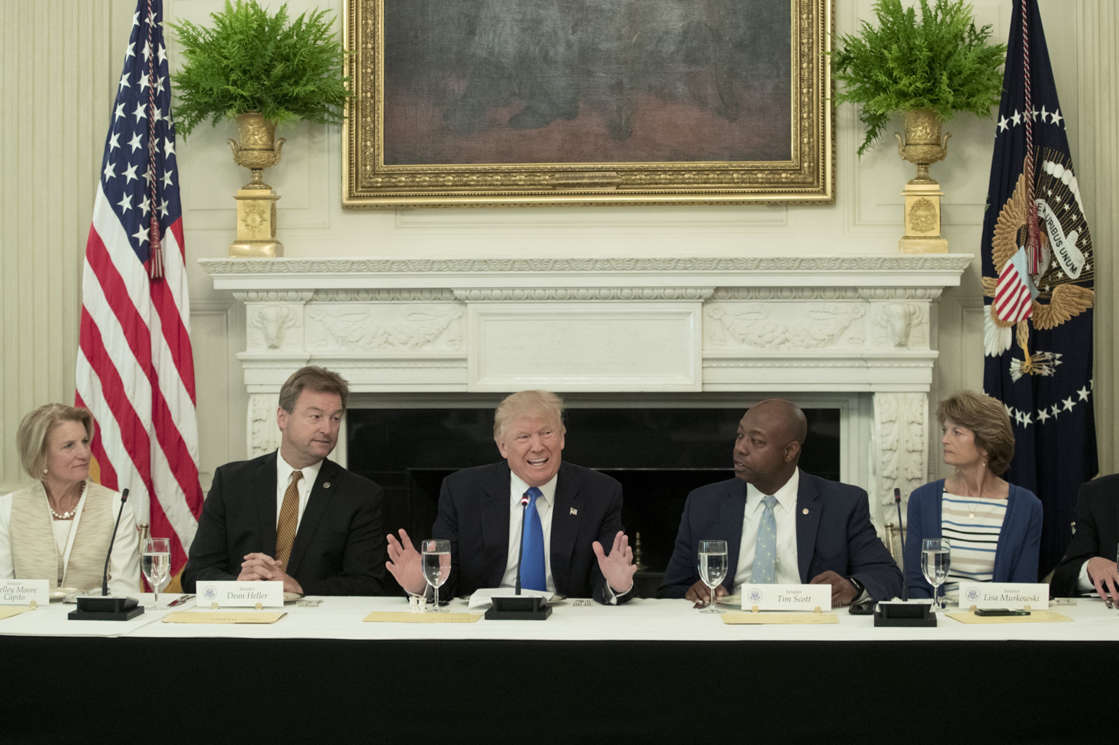 WASHINGTON, DC - JULY 19: (AFP OUT) US President Donald Trump (C) delivers remarks on health care and Republicans' inability thus far to replace or repeal the Affordable Care Act, during a lunch with members of Congress in the State Dining Room of the White House on July 19, 2017 in Washington, DC. Also in the picture (L to R); Sen. Shelley Moore Capito (R-WV), Sen. Dean Heller (R-NV), Sen. Tim Scott (R-SC) and Sen. Lisa Murkowski (R-AK). (Photo by Michael Reynolds - Pool/Getty Images)
