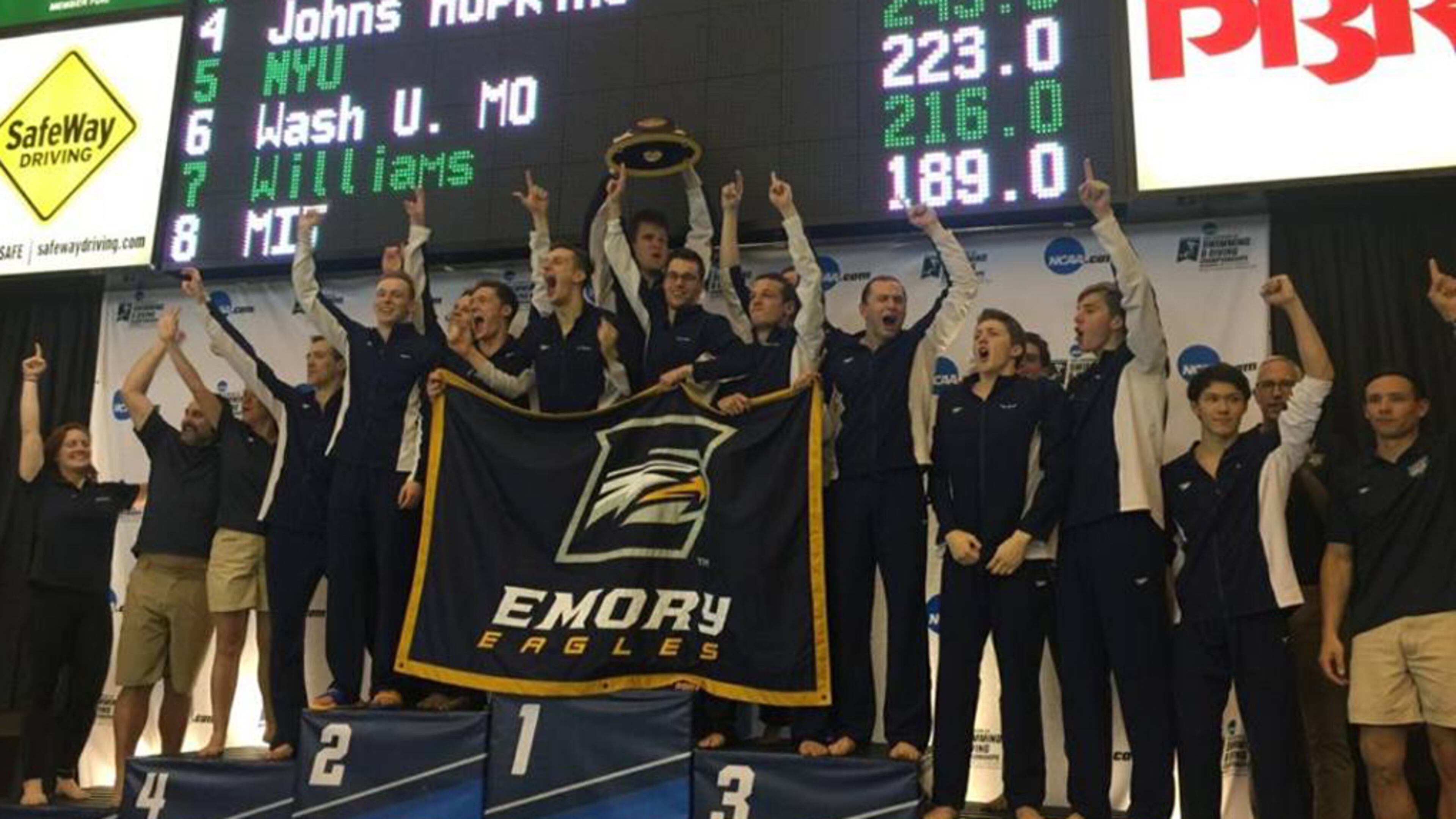The Emory men’s swim team on the winner’s podium on Saturday night in Shenandoa, Texas. (Photo courtesy of Emory)