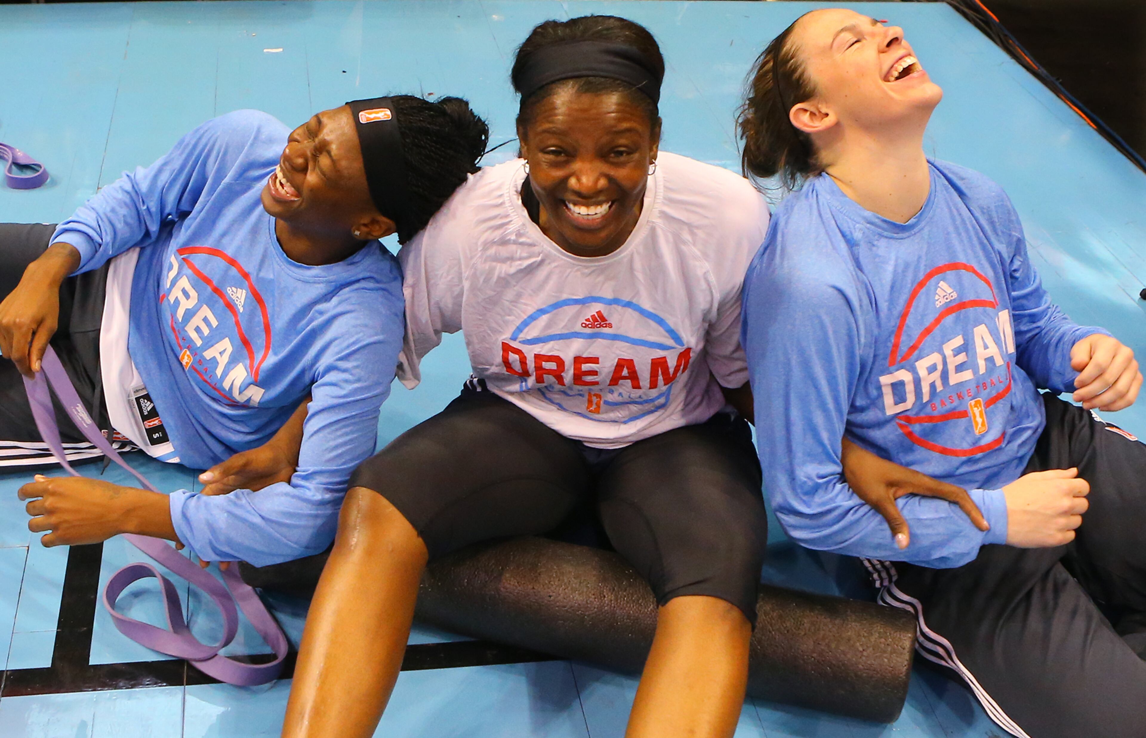 060715 Atlanta: Dream players Erica Wheeler (from left), DeLisha Milton-Jones and Samantha Logic share a laugh as they losen up for the opener against Connecticut at Philips Arena on Sunday, June 7, 2015, in Atlanta. Curtis Compton / ccompton@ajc.com