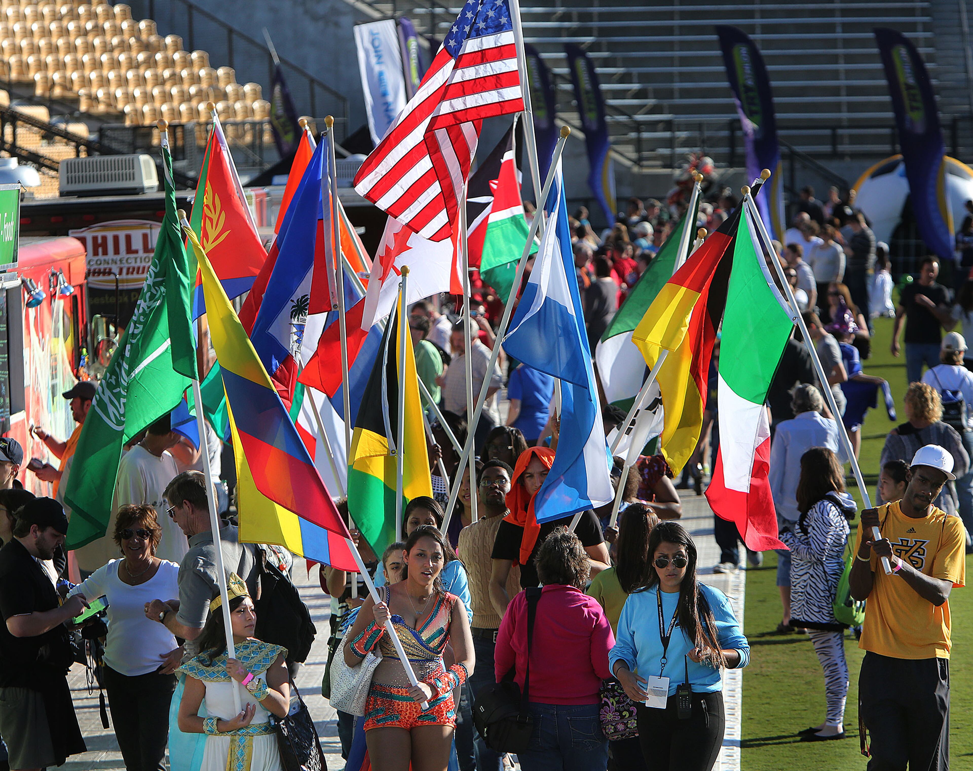 The International Student Association members marches with flags at the Kennesaw State University Owl-O-Ween, Atlanta's only hot air balloon festival also billed as Atlanta's largest costume party. Expected to attract crowd of 35,000-40,000 the two-day event featured tethered balloon more than 50 vendors, food trucks, 25 artisans and a special interactive children's area. Entertainment was provided by stilt walkers, fire breathers, ice sculptors, belly dancers, sword swallowers, roving buskers and art vendors. An Oktoberfest-inspired food court with German-themed entertainment and craft beer gardens was also available. (Photo by Phil Skinner)