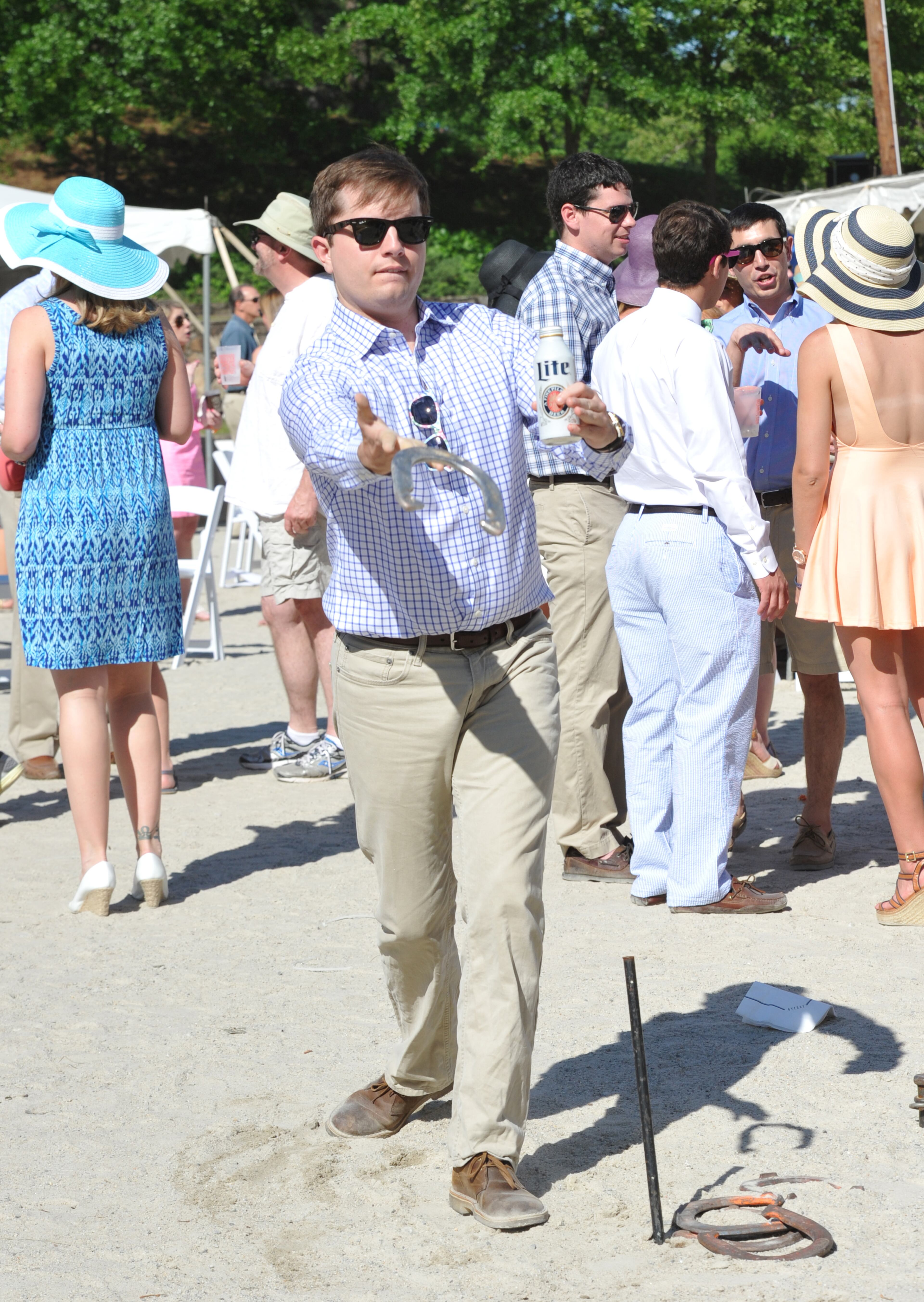 Andrew Gast, of Atlanta, throws a horseshoe during the annual Shepherd Center Derby Day at Chastain Horse Park on Saturday, April 3, 2014.