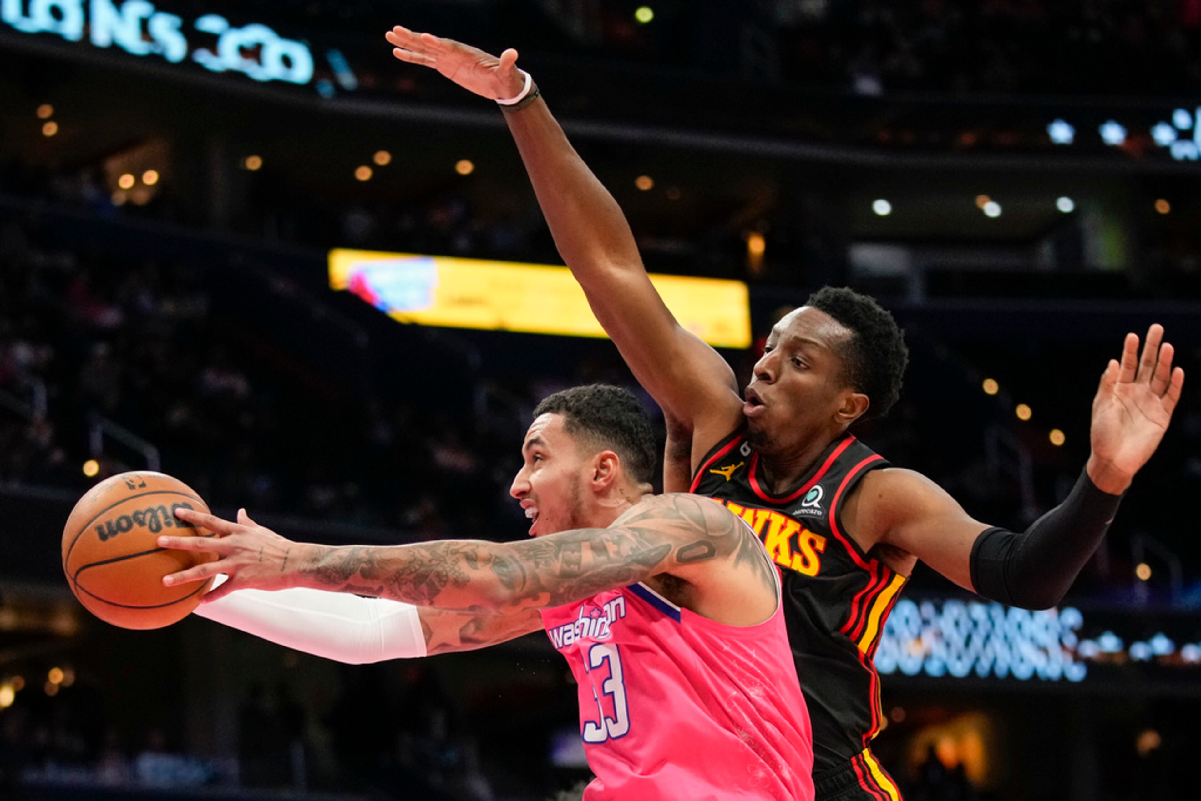 Washington Wizards forward Kyle Kuzma (33) shoots in front of Atlanta Hawks forward Onyeka Okongwu (17) during the first half of an NBA basketball game Wednesday, March 8, 2023, in Washington. The Hawks won 122-120. (AP Photo/Alex Brandon)