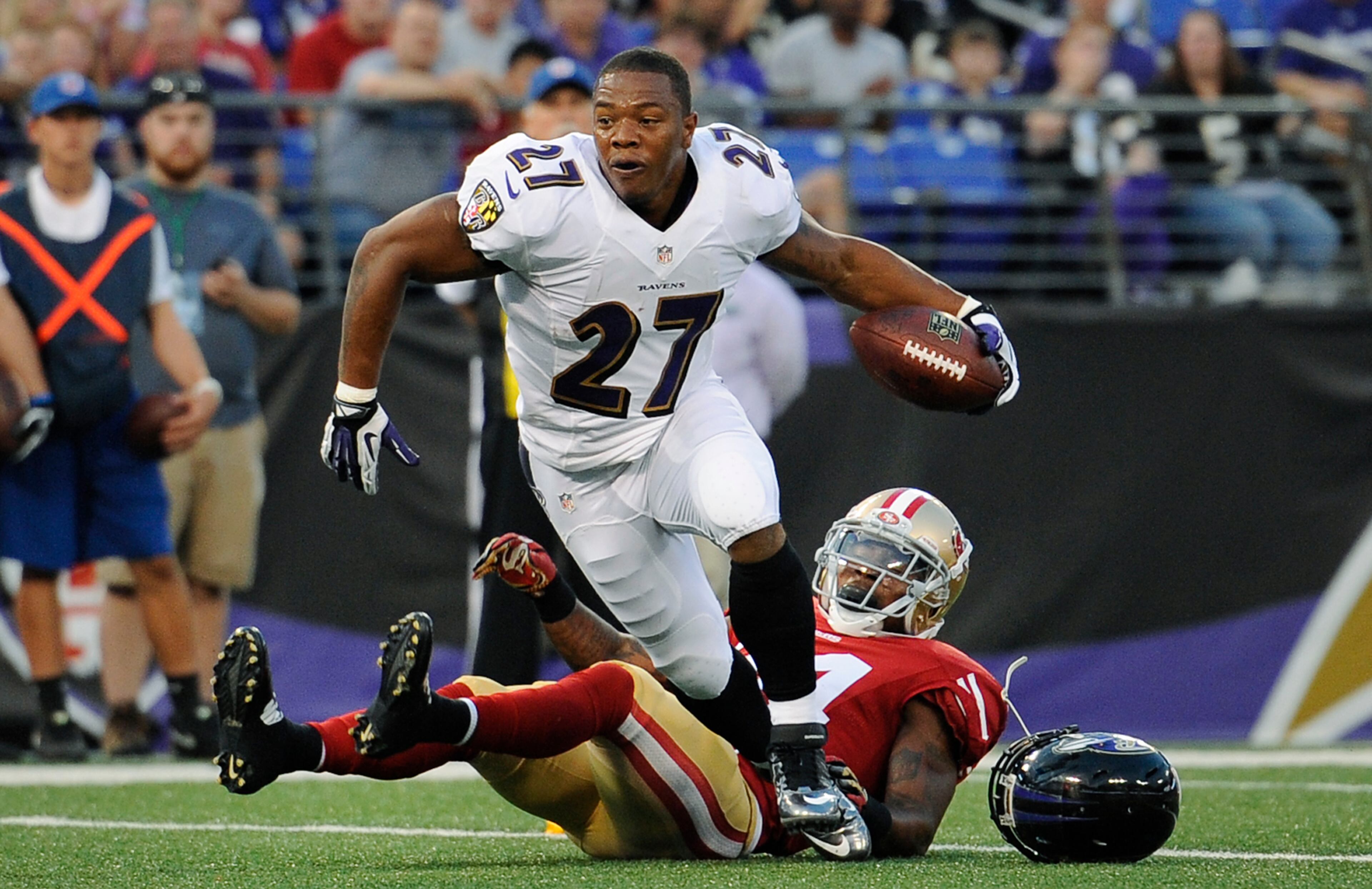 Baltimore Ravens running back Ray Rice (27) runs toward the end zone past San Francisco 49ers strong safety Antoine Bethea in the first half of an NFL preseason football game, Thursday, Aug. 7, 2014, in Baltimore. Rice did not score as the play was called dead after he lost his helmet. (AP Photo/Nick Wass)