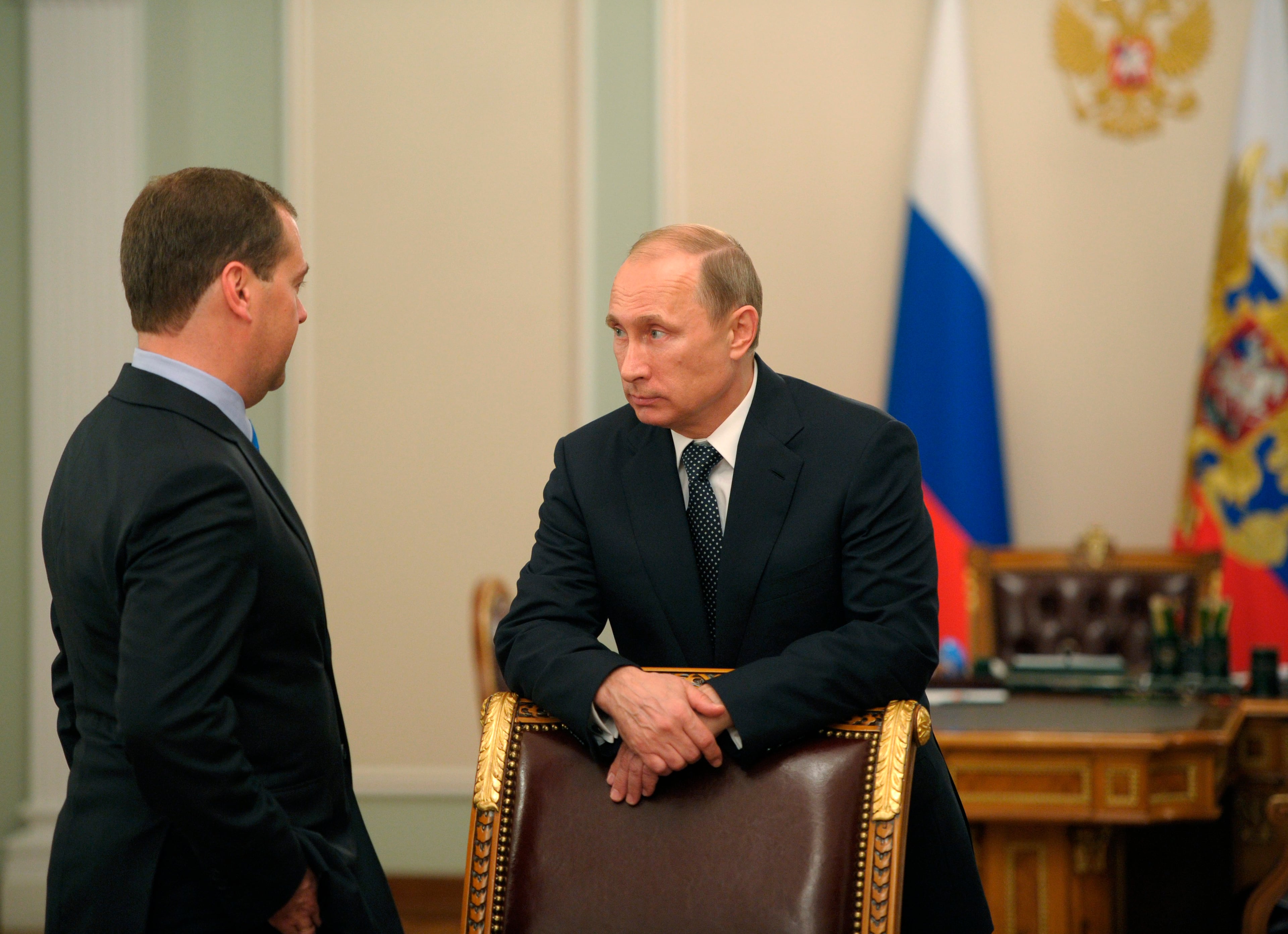 In this photo taken on Thursday, July 17, 2014, Russian President Vladimir Putin, right, speaks to Prime Minister Dmitry Medvedev after a moment of silence mourning the victims killed in the Malaysia Airlines plane crash on Thursday, July 17, in Donetsk region of Ukraine prior a meeting at the Novo-Ogaryovo residence outside Moscow. (AP Photo/RIA-Novosti, Alexei Druzhinin, Presidential Press Service)