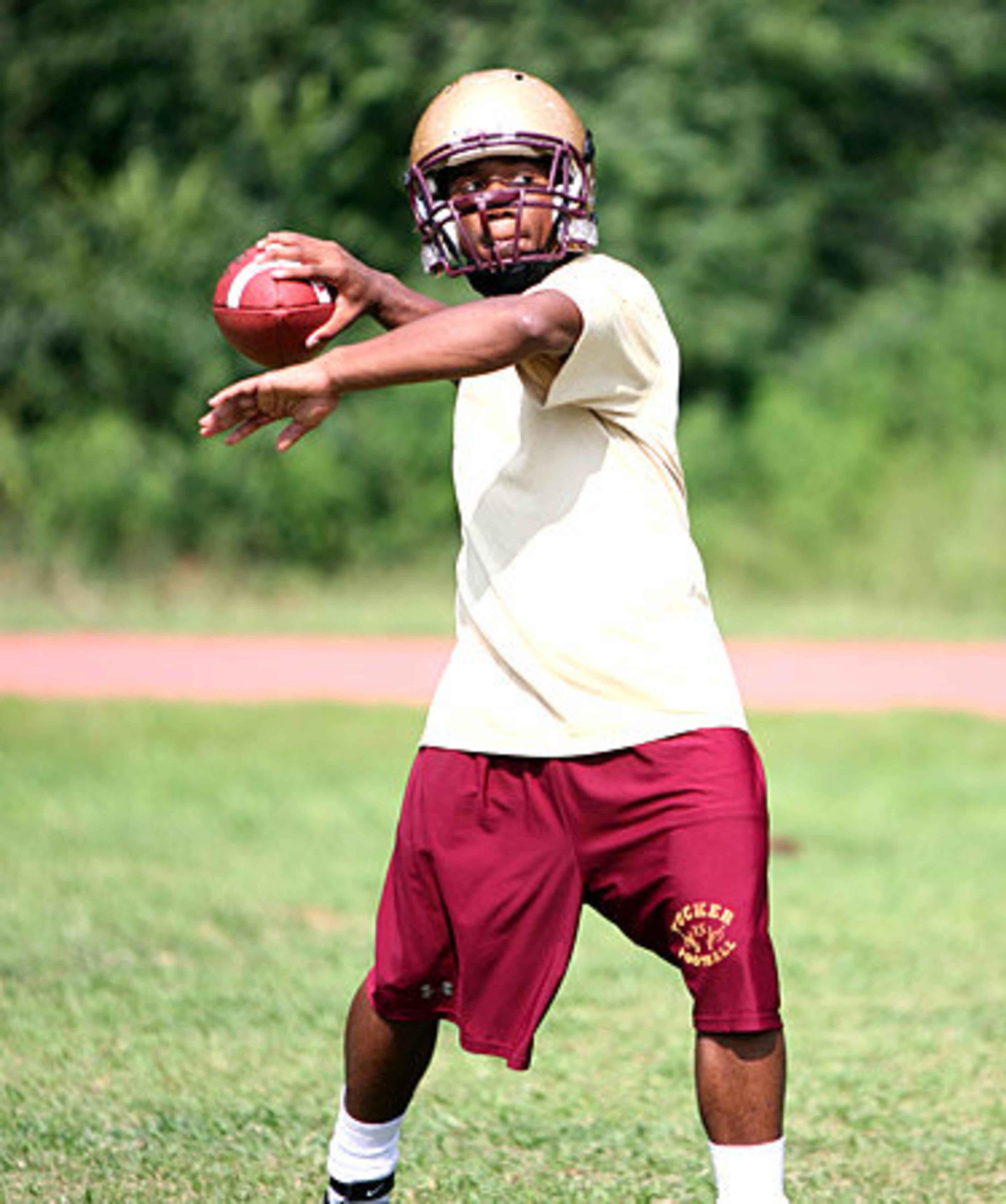 Tigers RB/CB Devin Scott loosens up with some throwing exercises.