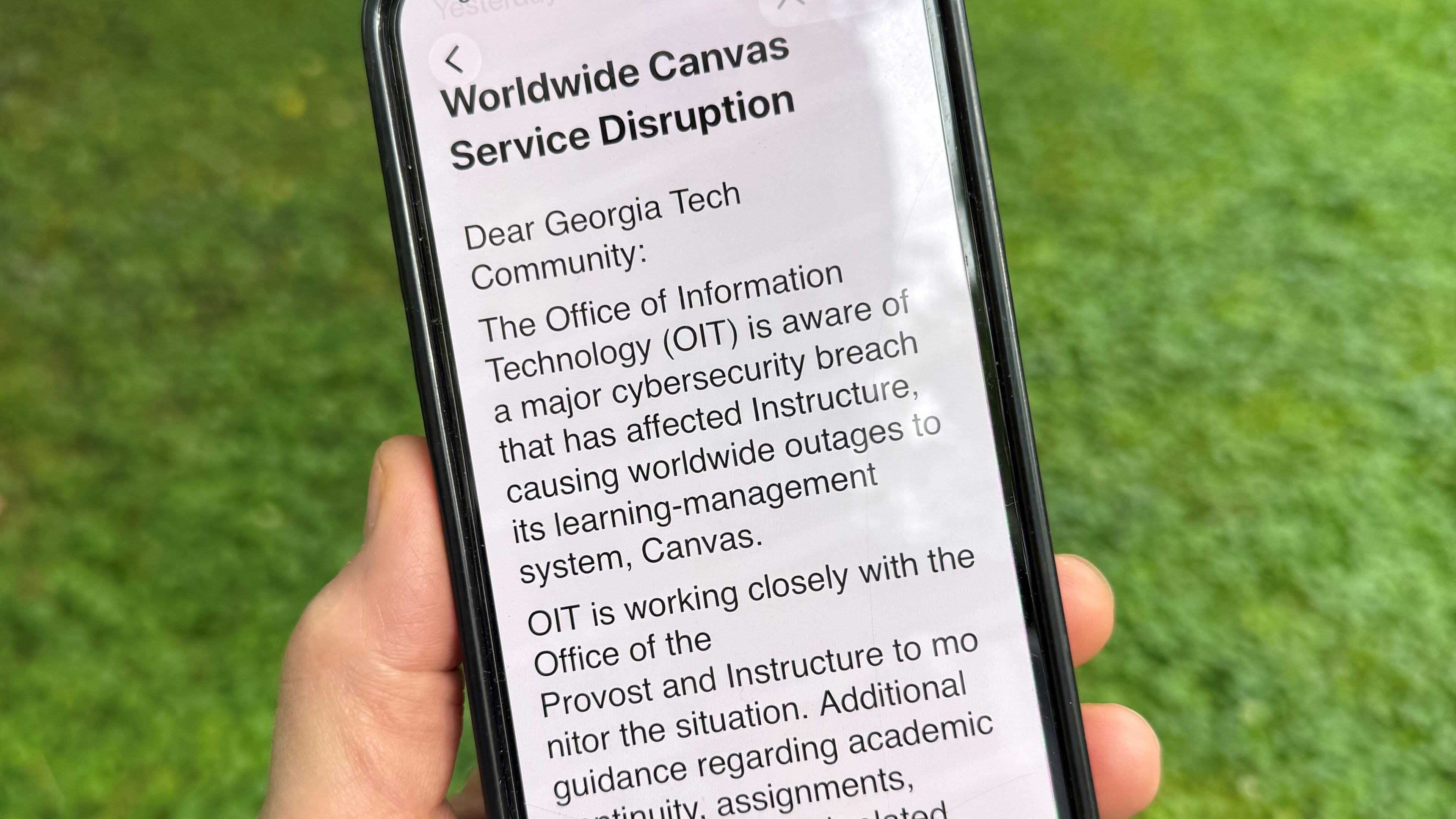 An image of a notice sent by Georgia Tech's information technology department warning students, professors and staff about the cybersecurity breach of the Canvas system it uses for assignments and grading is displayed on a phone, Friday, May 8, 2026, in Decatur, Georgia. (AP Photo/Michael Warren)