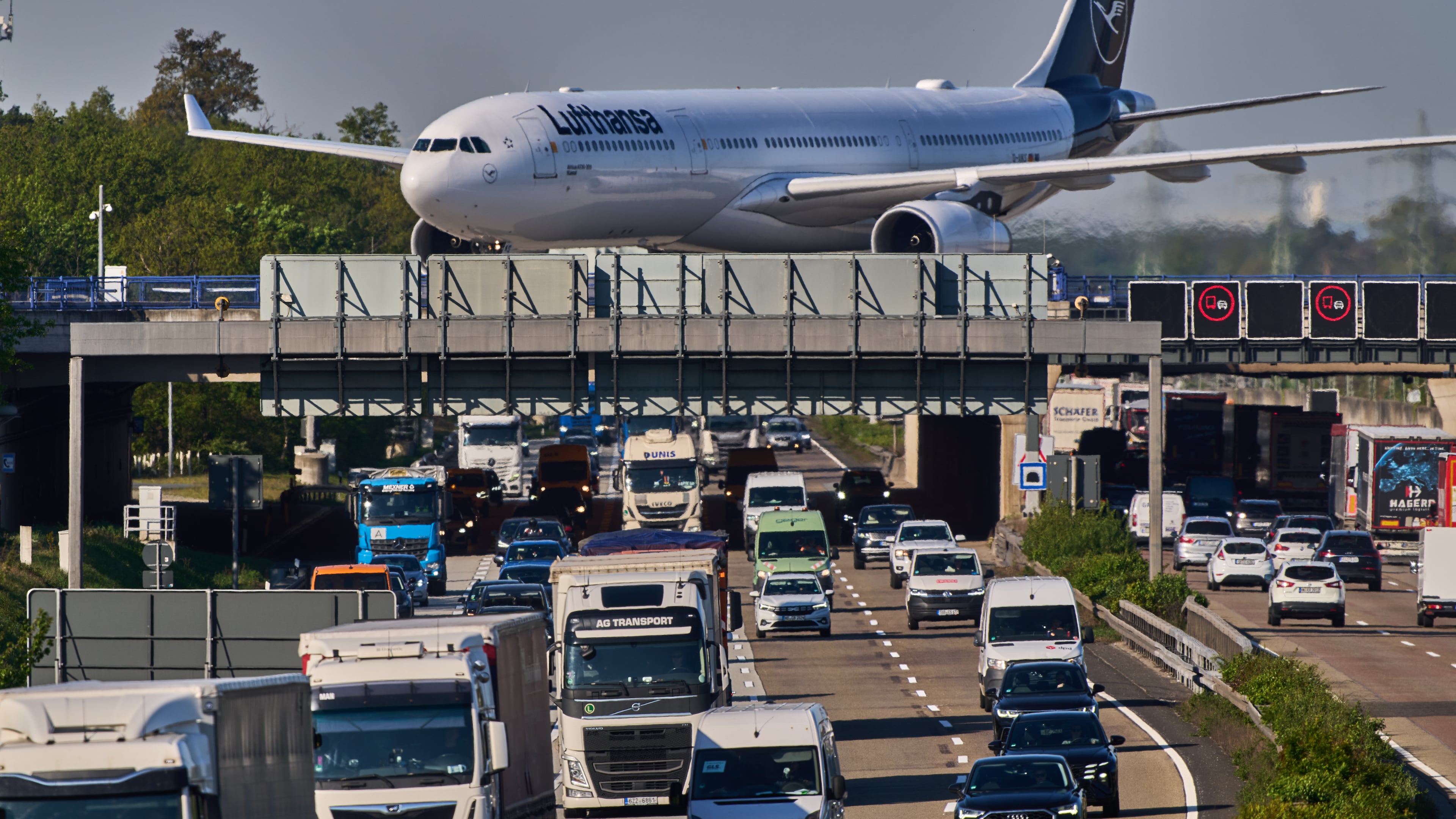 A Lufthansa aircraft rolls on a bridge over a highway at the airport in Frankfurt, Germany, Wednesday, April 22, 2026. (AP Photo/Michael Probst)