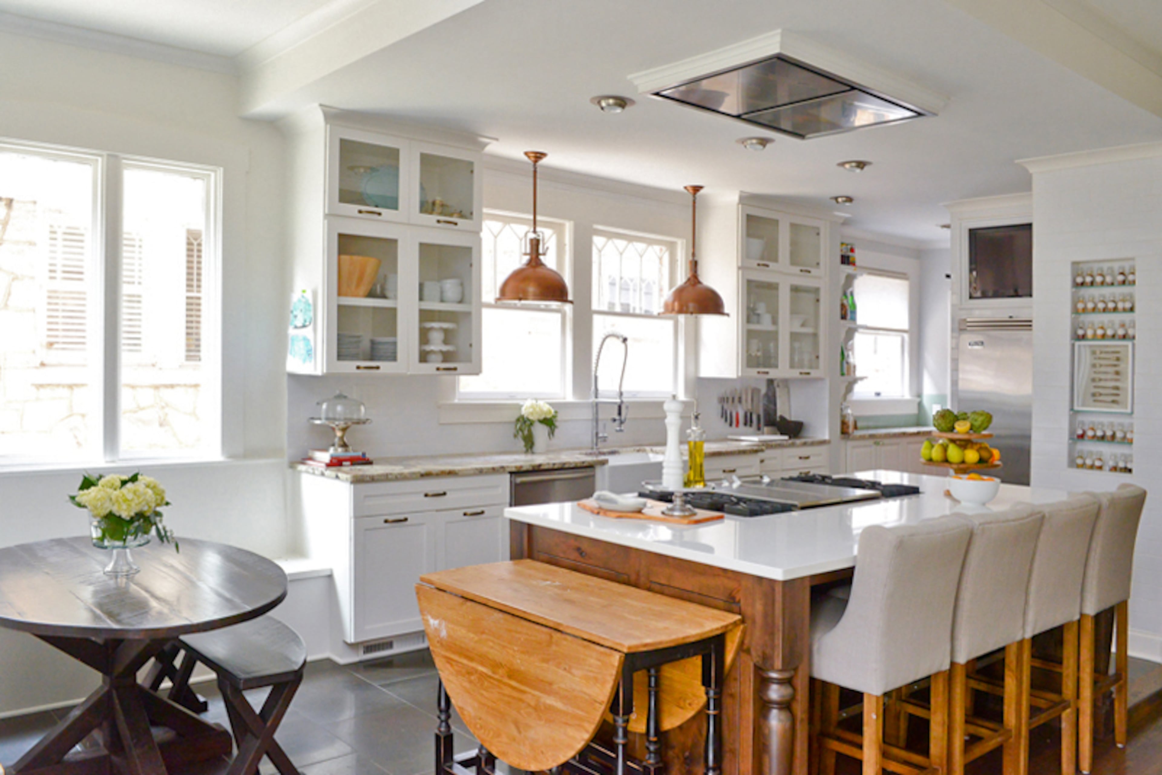 Eryn Houck loves that her kitchen opens up to the keeping room, where her family spends most of their time. The bright, open space also features a banquette with storage and plenty of seating for the family of five. Four bar chairs from Joss and Main tuck under the island and provide even more seating.