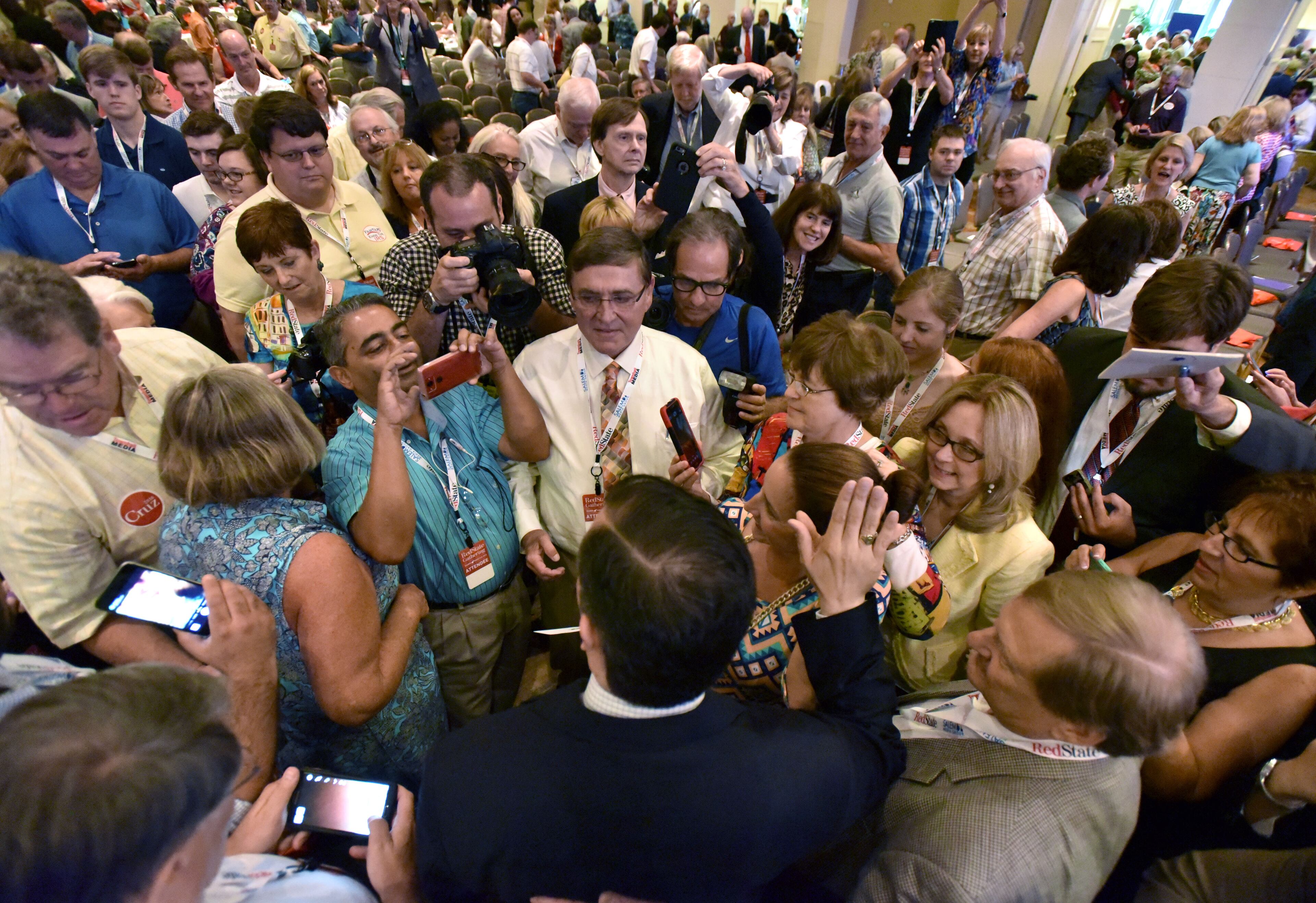 August 8, 2015 Atlanta - Texas Sen. Ted Cruz (foreground) is surrounded by his supporters after his speech during the RedState Gathering at Intercontinental Buckhead Hotel on Saturday, August 8, 2015. The organizer of the RedState Gathering has rescinded the Republican presidential candidate's invitation to speak at a Saturday evening rally at the College Football Hall of Fame. Erick Erickson said the billionaire's comments about Fox News anchor Megyn Kelly were "a bridge too far." Trump told CNN on Friday that "you could see there was blood coming out of her eyes. Blood coming out of her wherever" as she questioned him during Thursday's Republican presidential debate.HYOSUB SHIN / HSHIN@AJC.COM