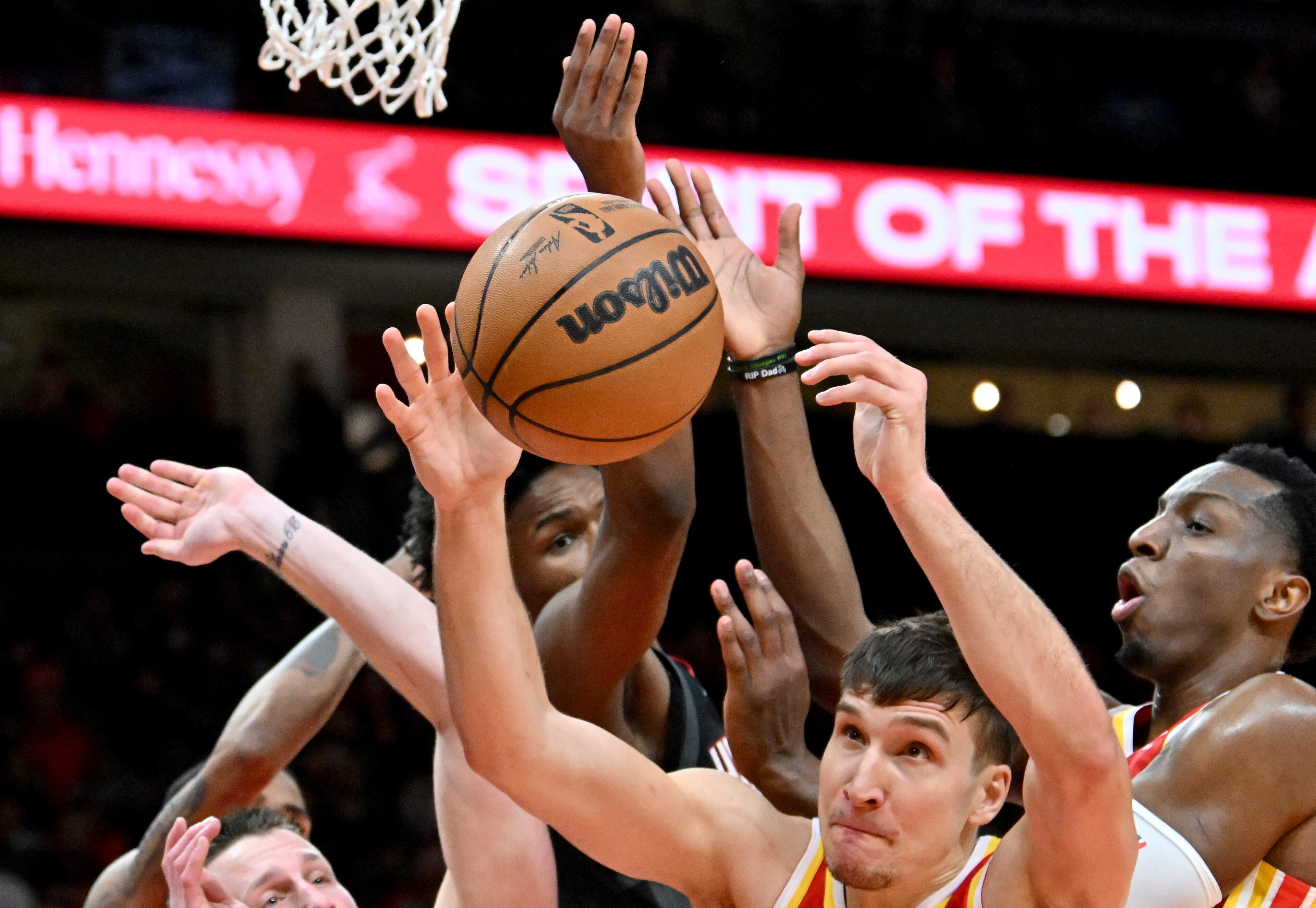 Atlanta Hawks guard Bogdan Bogdanovic (center) grabs a rebound during the first half. (Hyosub Shin / Hyosub.Shin@ajc.com)