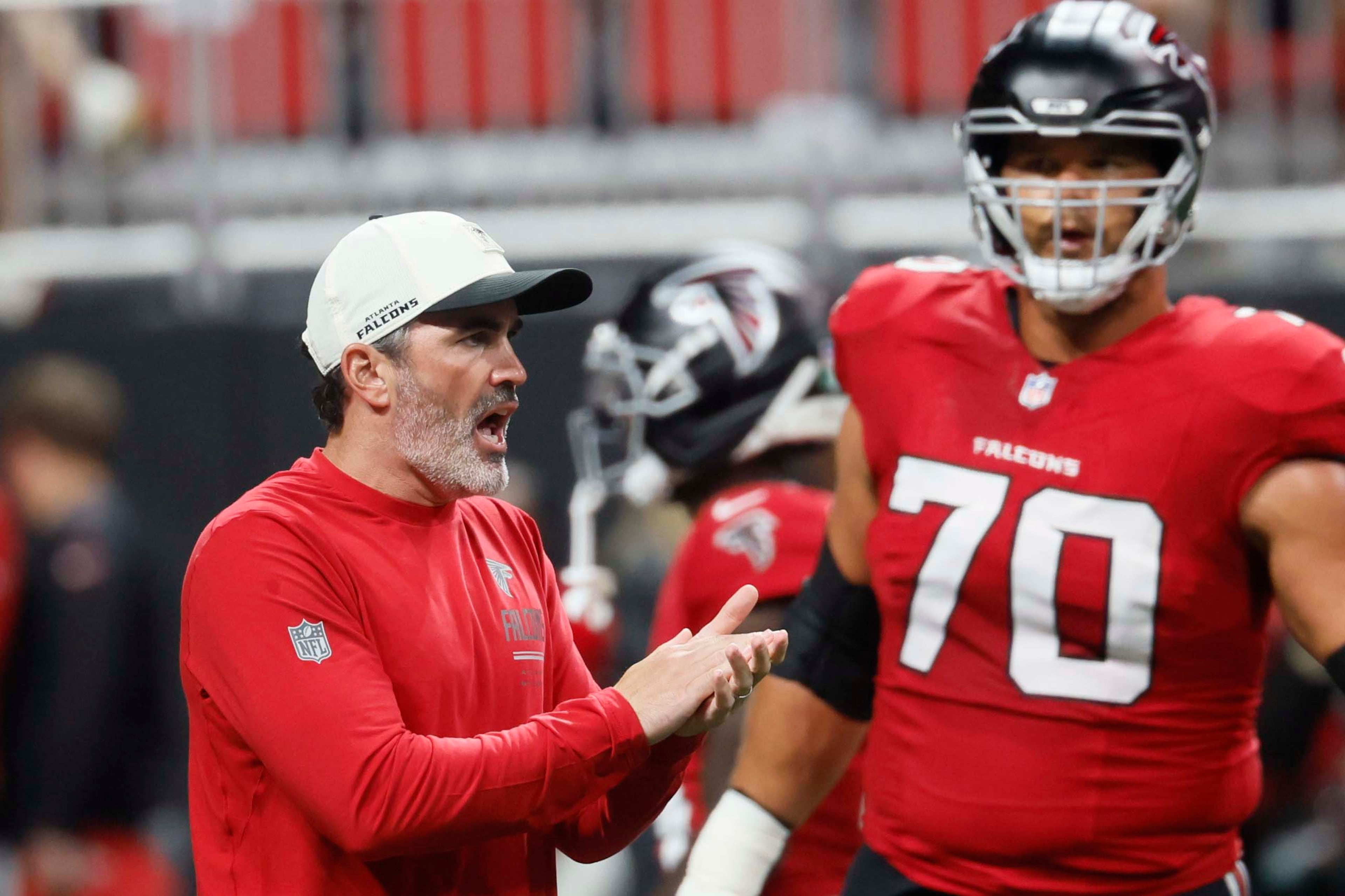 Atlanta Falcons head coach Kevin Stefanski cheers his team during warm-ups before Sunday's game against the Baltimore Ravens at Mercedes-Benz Stadium in Atlanta on Oct. 11, 2026. (Miguel Martinez/AJC)