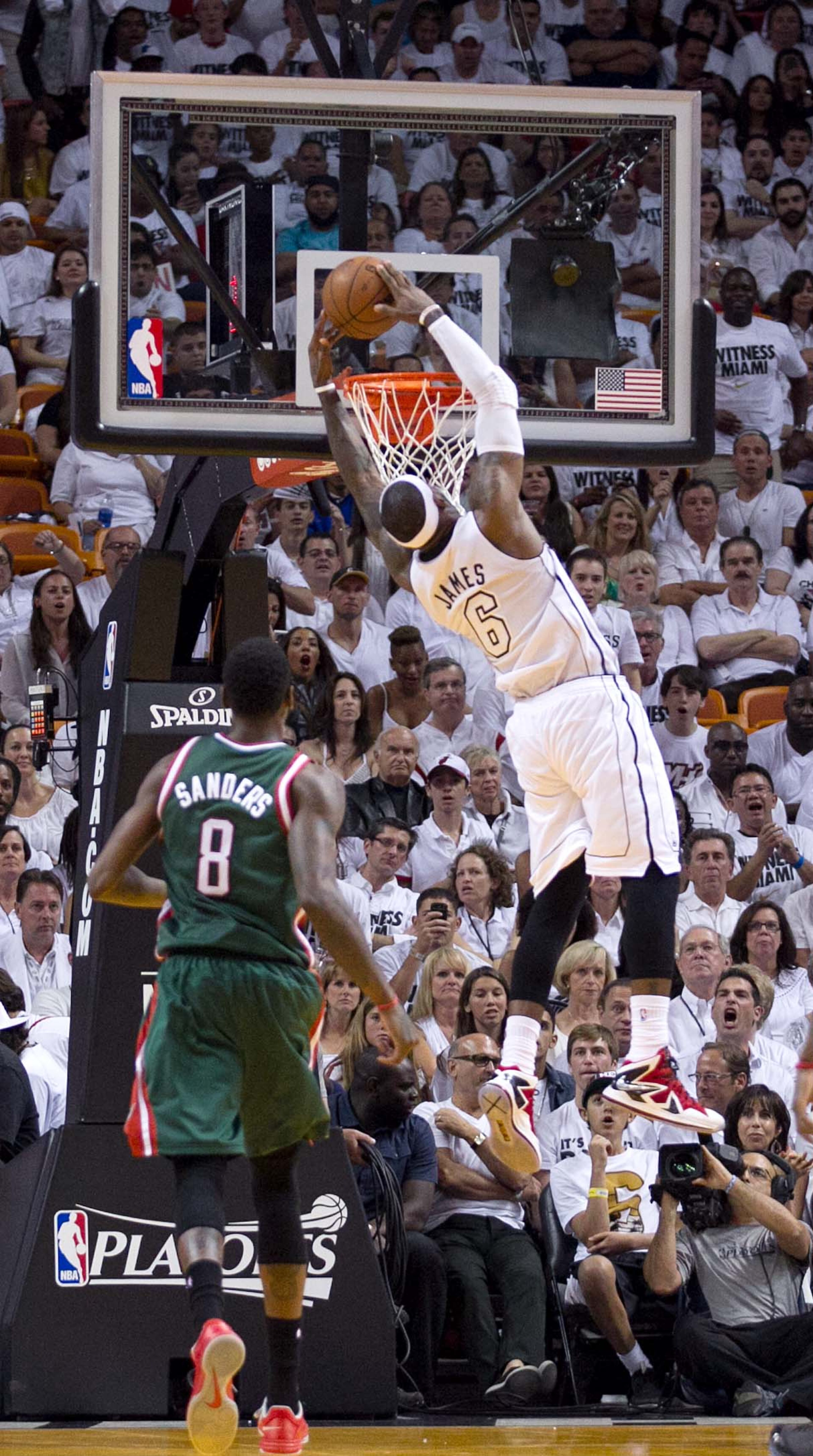 Miami Heat small forward LeBron James (6) jams home a lob pass from Miami Heat shooting guard Ray Allen (34) in the fourth quarter as Milwaukee Bucks center Larry Sanders (8) looks on at AmericanAirlines Arena on April 21, 2013. (Allen Eyestone/The Palm Beach Post)