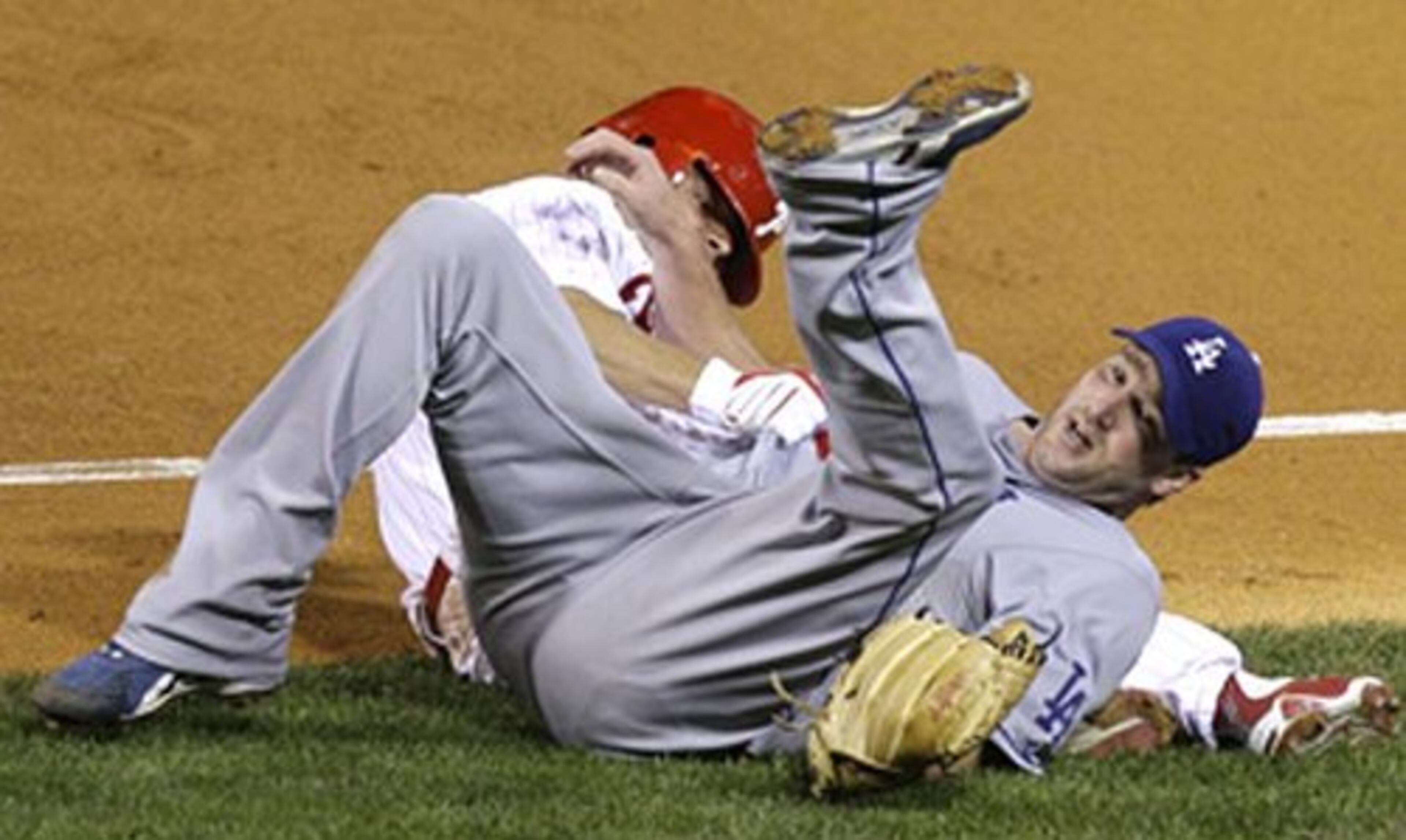 Lowe isn't afraid to get down and dirty off the mound, here mixing it up with the Phillies' Shane Victorino at first base during Game 1 of the 2008 National League championship series. The Dodgers lost to Philly, the eventual World Series champs.
