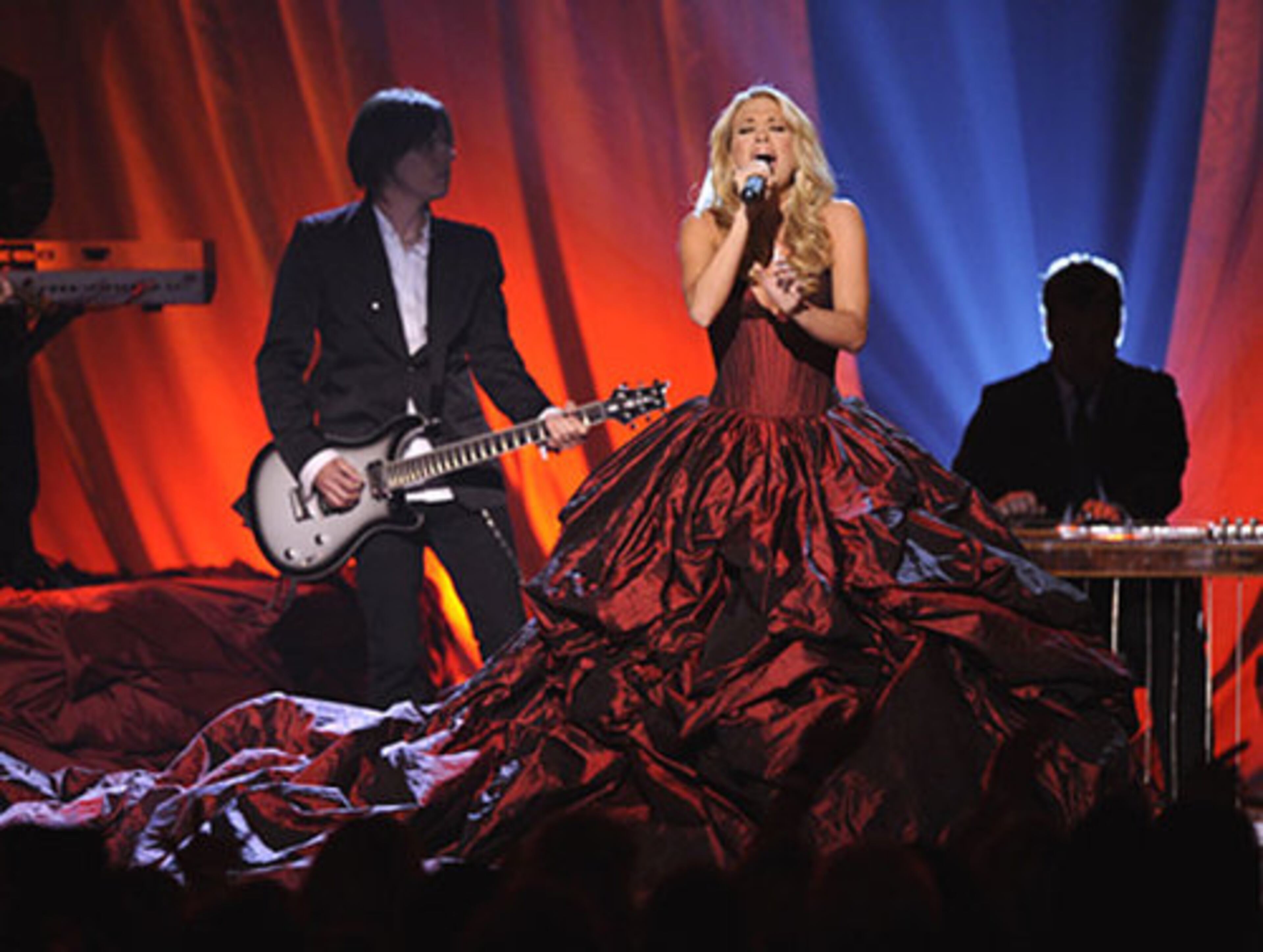 Carrie Underwood, who won Entertainer of the Year, performs "I Told You So" -- and she had, saying she'd be wearing 'a lot of dress.' The dress had been kept secret.