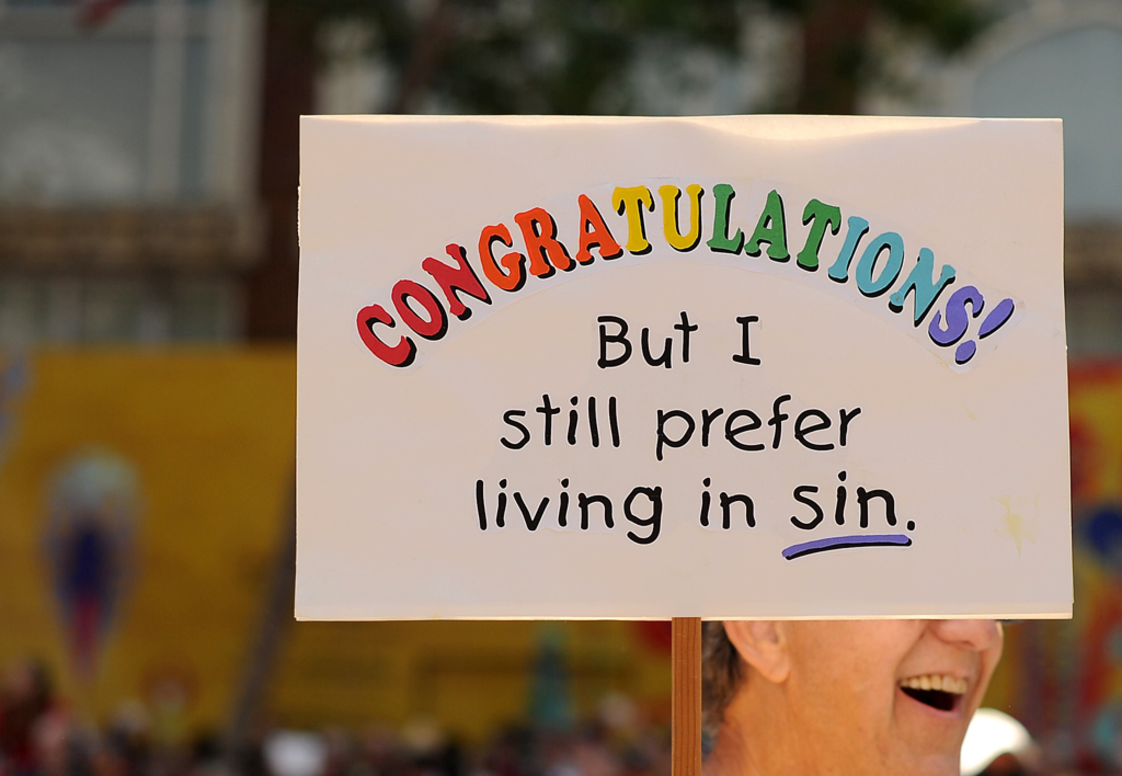 Tom Shamp carries a sign referencing a U.S. Supreme Court decision that cleared the way for same-sex marriage in California while marching in San Francisco's 43rd annual gay pride parade Sunday, June 30, 2013. Shamp, who has been with his male partner for 45 years, says he has no plans to marry . (AP Photo/Noah Berger)