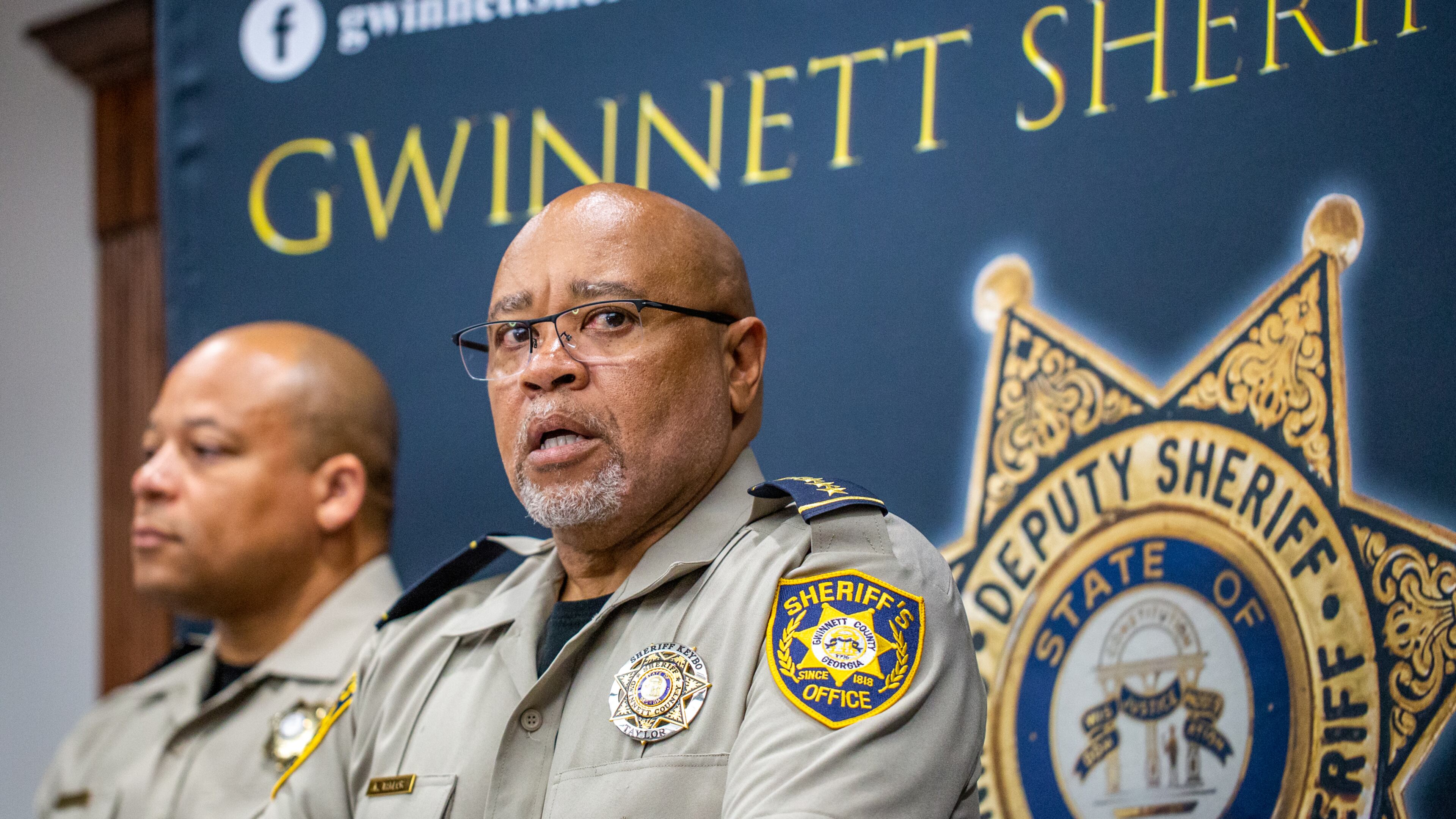 Gwinnett County Sheriff Keybo Taylor, right, addresses the press at the Gwinnett Sheriff's Office in Lawrenceville with Chief Cleophas Atwater, left, at his back, on Tuesday, June 29, 2021. Sheriff Taylor addresses an extortion lawsuit against him initiated by staff at a bail bonds company which has concluded, the bond service has retracted the lawsuit. (Jenni Girtman for The Atlanta Journal-Constitution