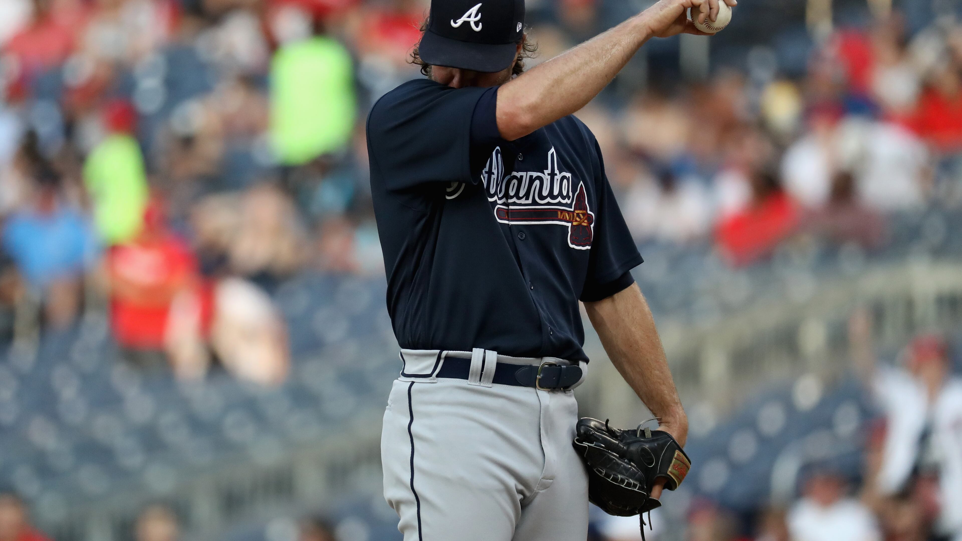 Starting pitcher R.A. Dickey of the Braves reacts after giving up back-to-back home runs. (Photo by Rob Carr/Getty Images)