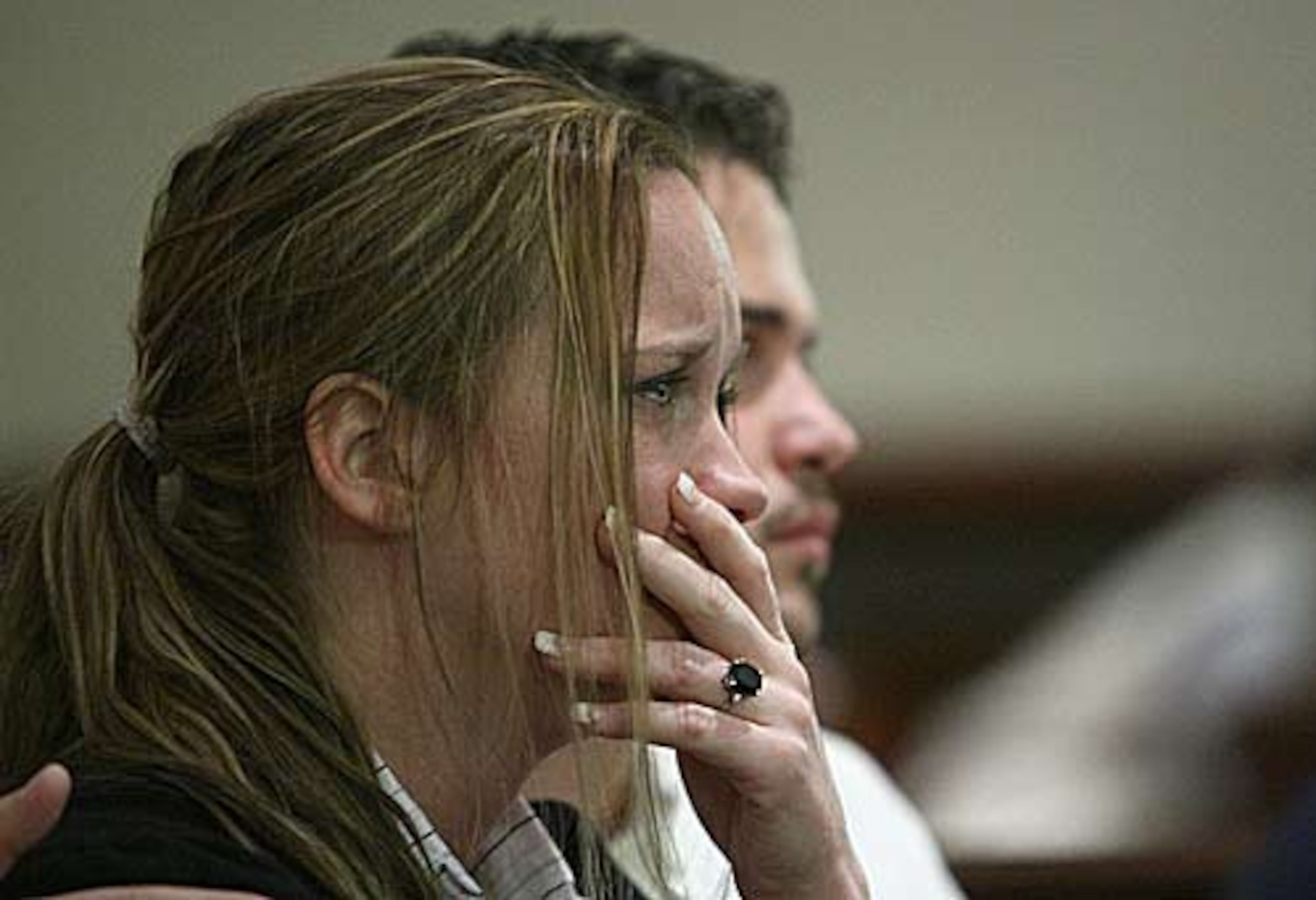 Kiley Barnes, daughter of Judge Rowland Barnes becomes emotional while listening to Nichols, via video, describe her father as a master and a target.