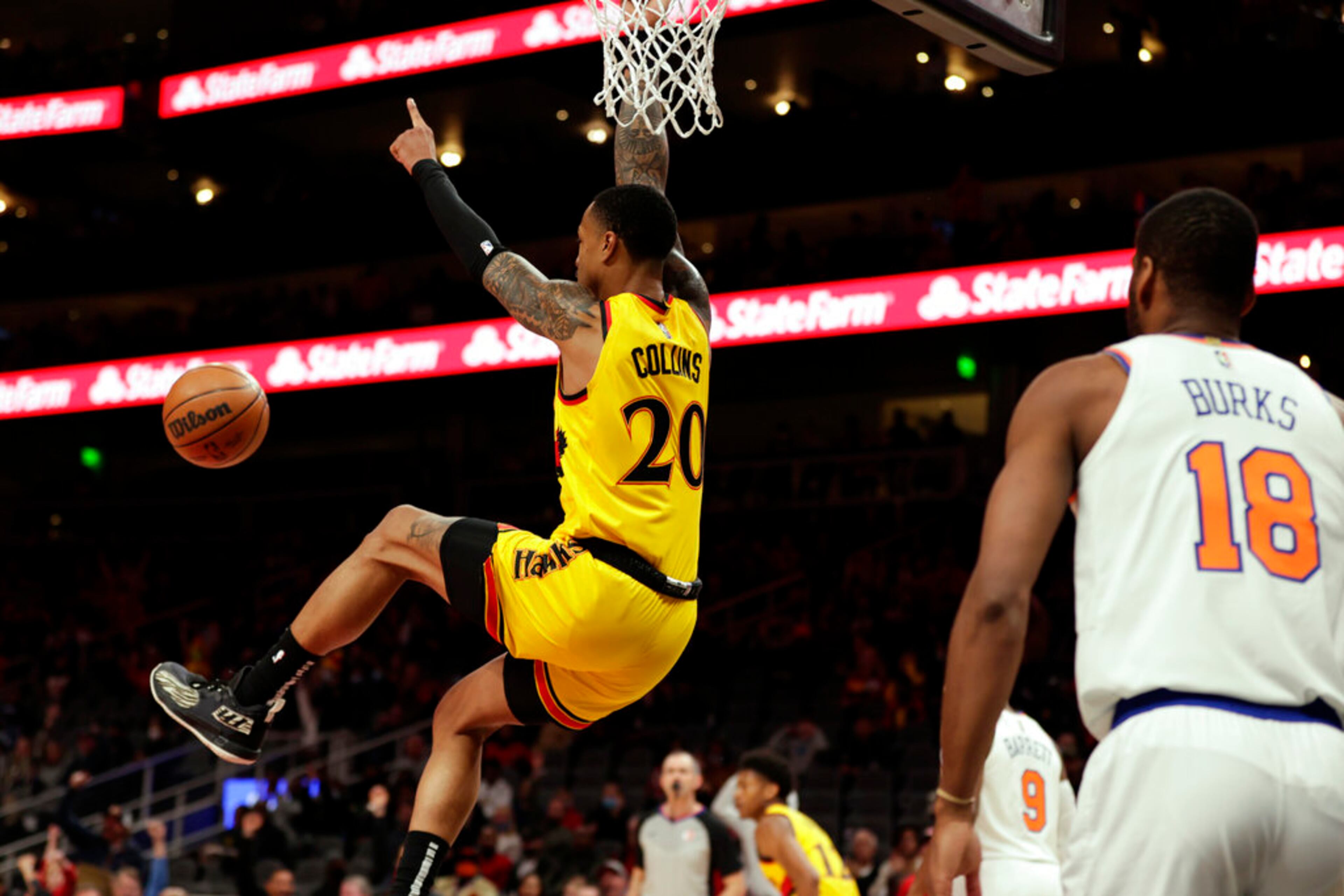 Hawks forward John Collins (20) reacts after dunking the ball over Knicks forward Obi Toppin (1) during the first half. (AP Photo/Butch Dill)