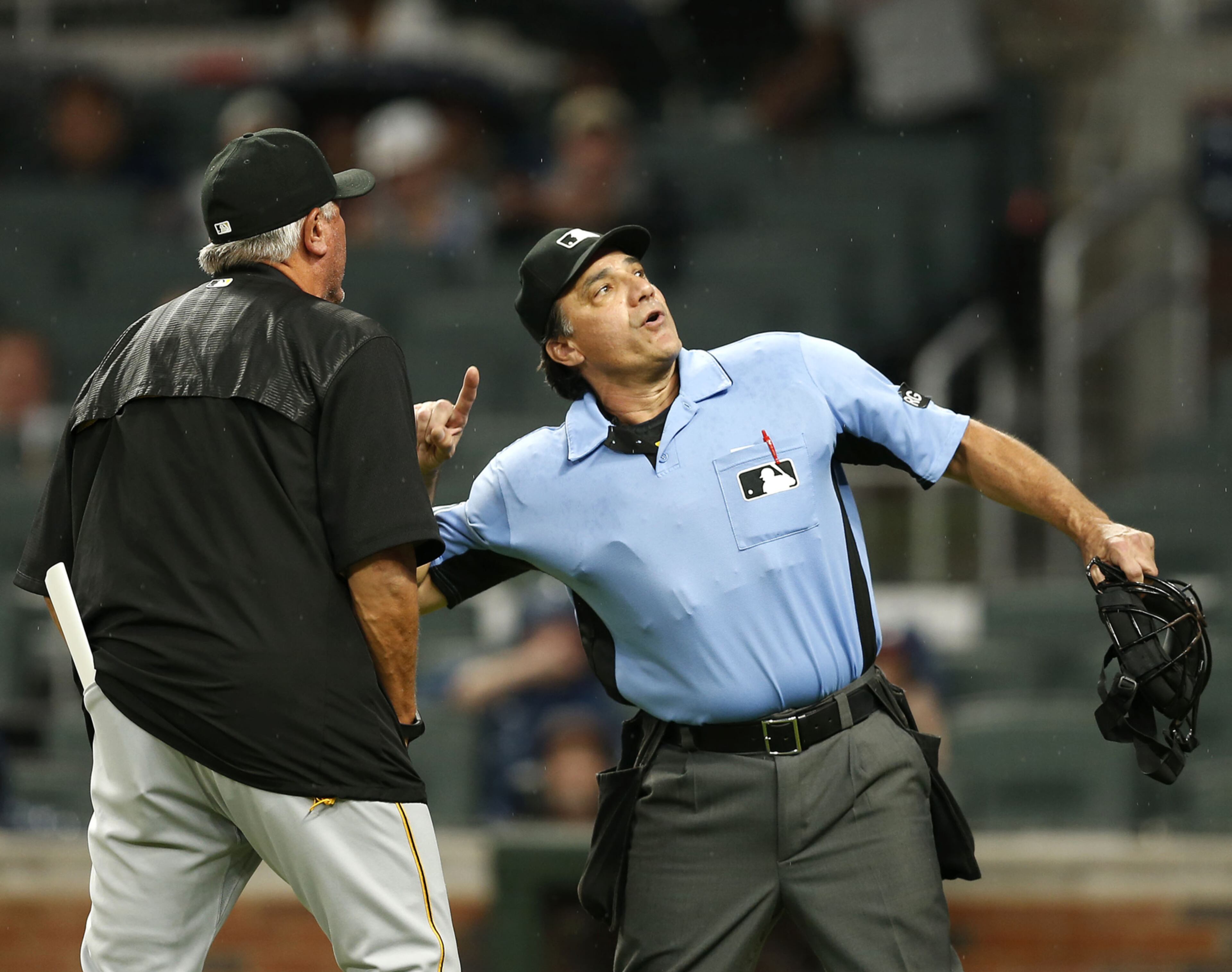 ATLANTA, GA - MAY 22: Home plate umpire Phil Cuzzi #10 throws manager Clint Hurdle #13 of the PIttsburgh Pirates out of the game in the fourth inning during the game against the Atlanta Braves at SunTrust Park on May 22, 2017 in Atlanta, Georgia. (Photo by Mike Zarrilli/Getty Images)