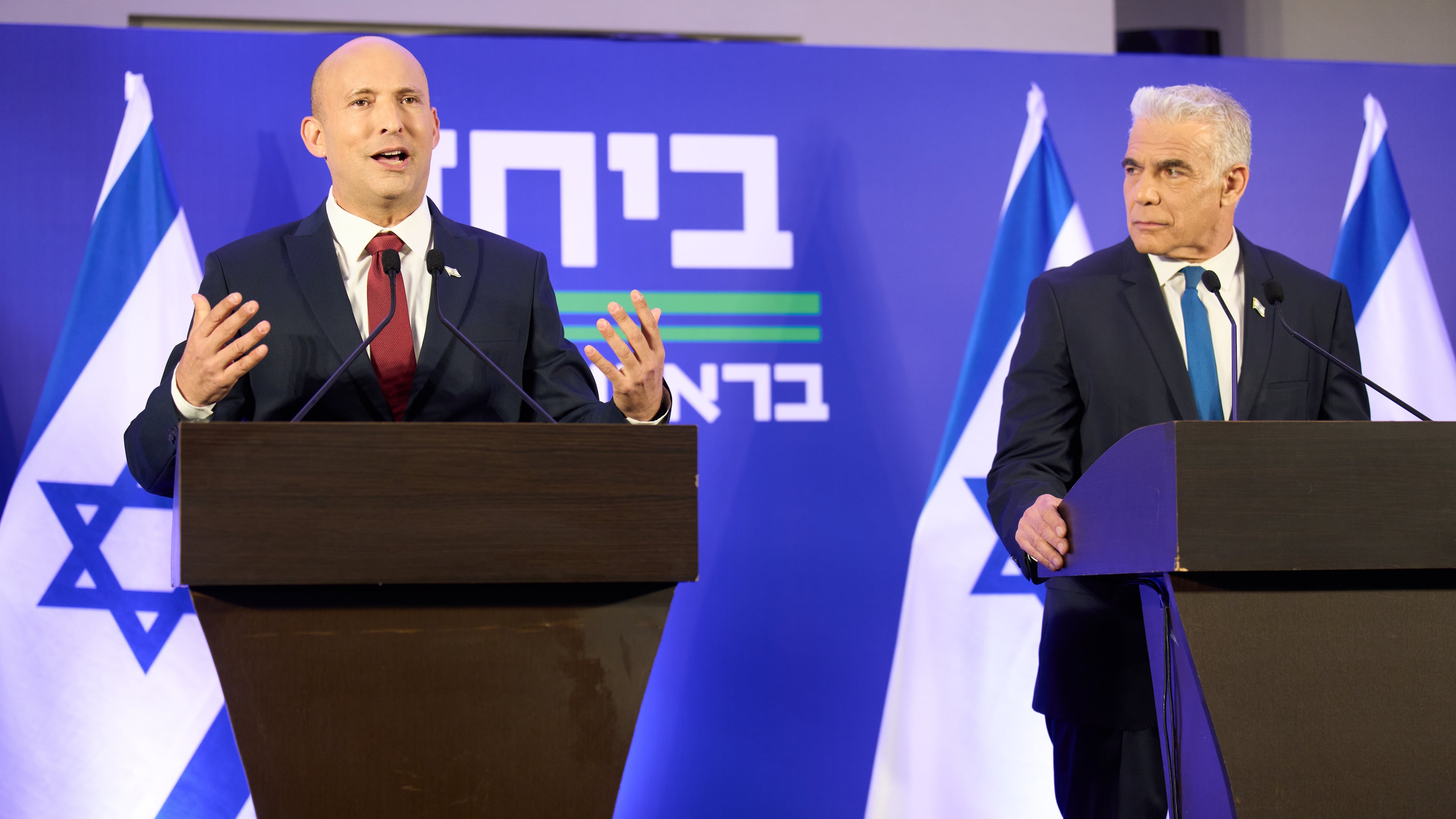 Former Israeli prime ministers Naftali Bennett, left, and Yair Lapid hold a joint press conference announcing that their parties will run together in the upcoming elections, in Herzliya, Israel, Sunday, April 26, 2026. (AP Photo/Ariel Schalit)