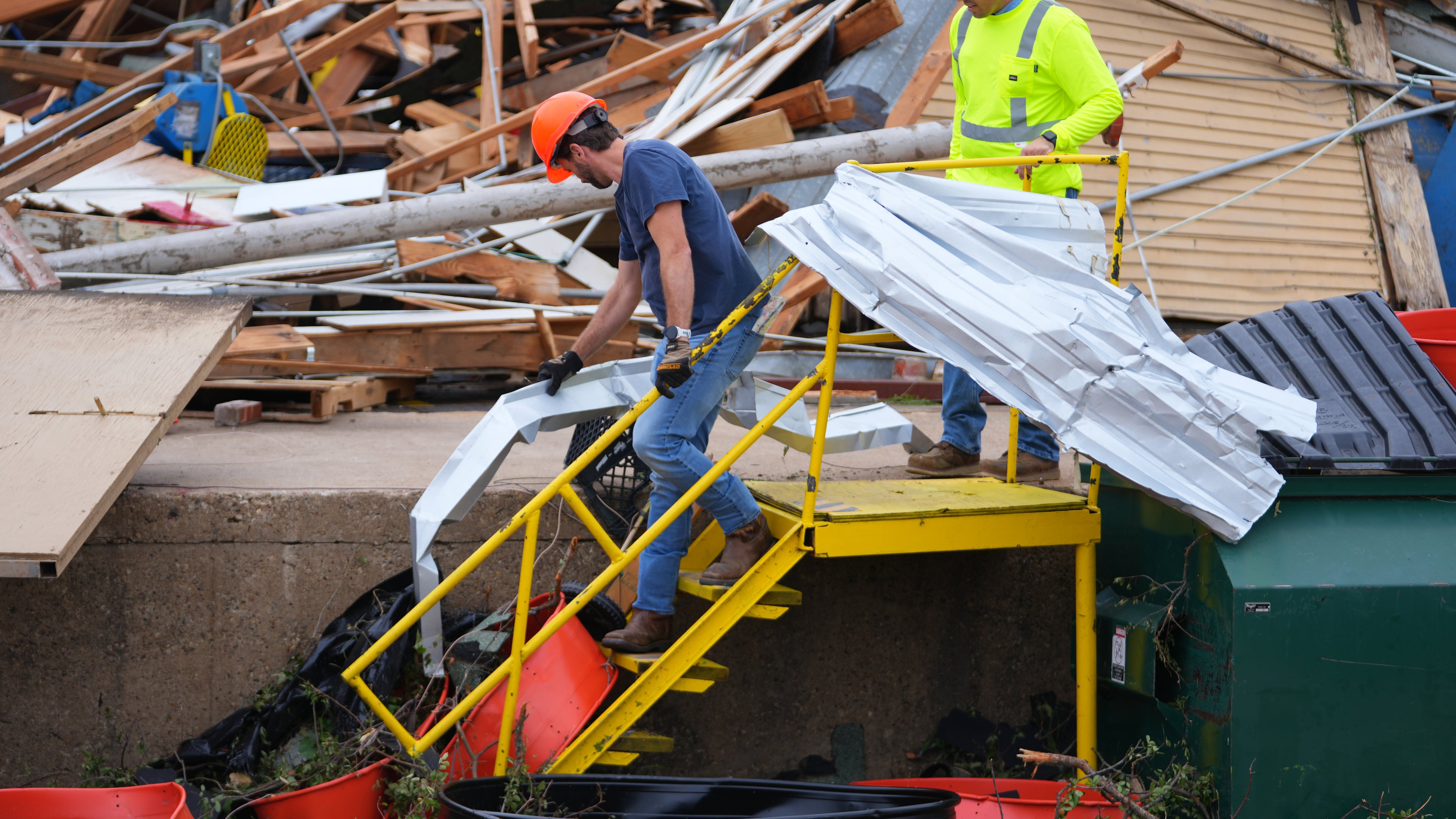People clear debris following a storm in Mineral Wells, Texas, Wednesday, April 29, 2026. (AP Photo/Julio Cortez)