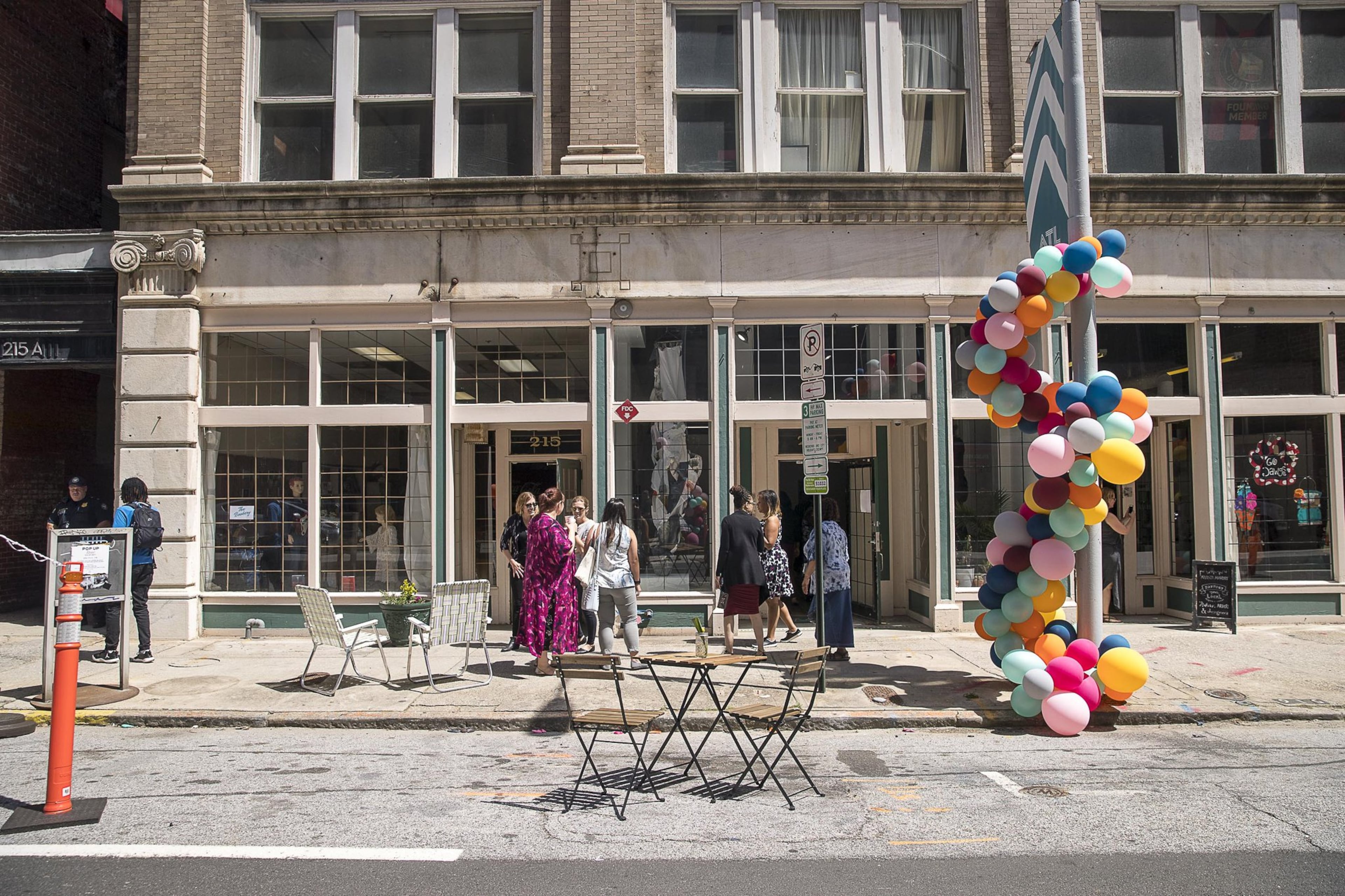People gather along Mitchell Street during a “Pop-Up Row” shopping event in Atlanta’s south downtown community. (ALYSSA POINTER/ALYSSA.POINTER@AJC.COM)