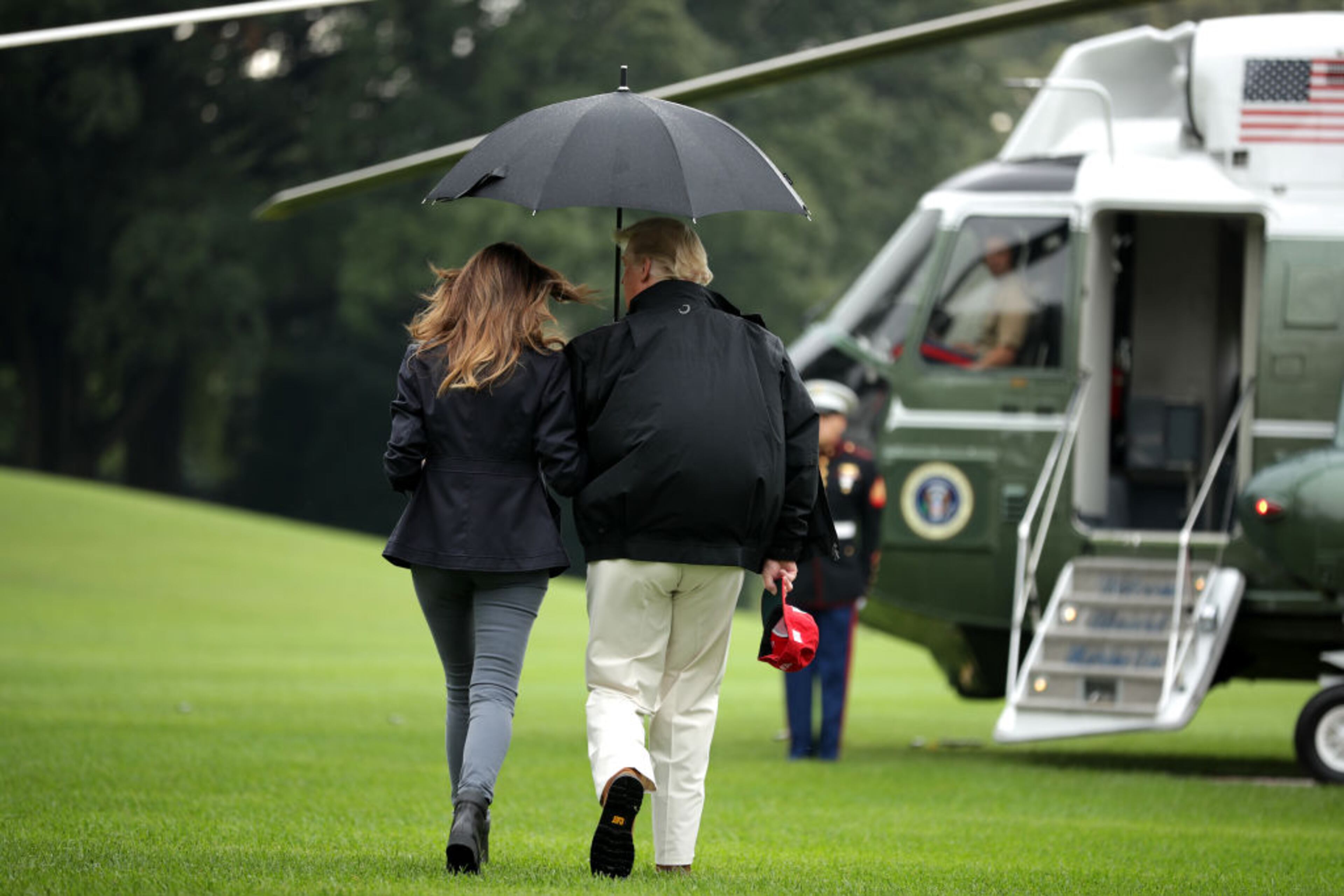 U.S. President Donald Trump (R) and and first lady Melania Trump walk across the South Lawn before boarding Marine One and leaving the White House October 15, 2018 in Washington, DC. The Trumps are traveling to survey damage from Hurricane Michael, the most powerful storm ever recorded to strike the Florida panhandle.