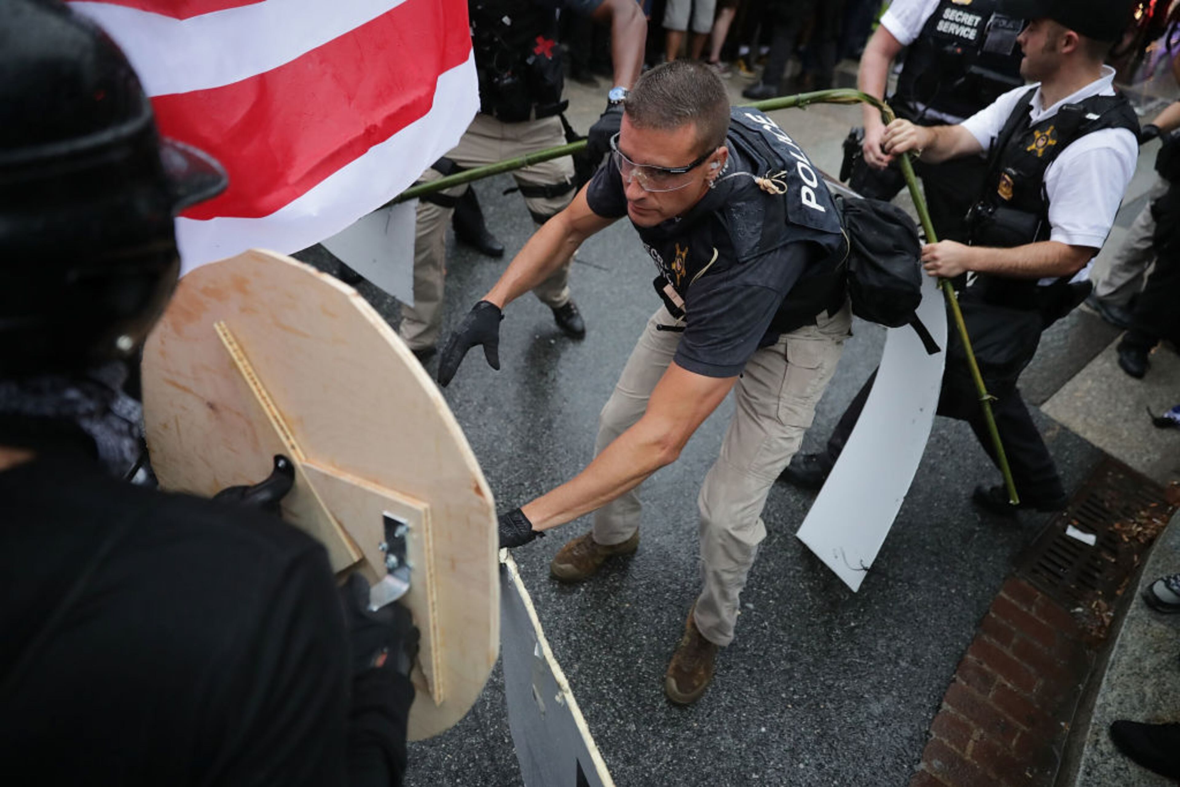 WASHINGTON, DC - AUGUST 12: Agents from the U.S. Secret Service clash with members of the Blac Bloc on the east side of the White House on the periphery of the white supremacist Unite the Right rally August 12, 2018 in Washington, DC. Thousands of protesters are expected to demonstrate against the "white civil rights" rally in Washington, which was planned by the organizer of last year's deadly rally in Charlottesville, Virginia. (Photo by Chip Somodevilla/Getty Images)
