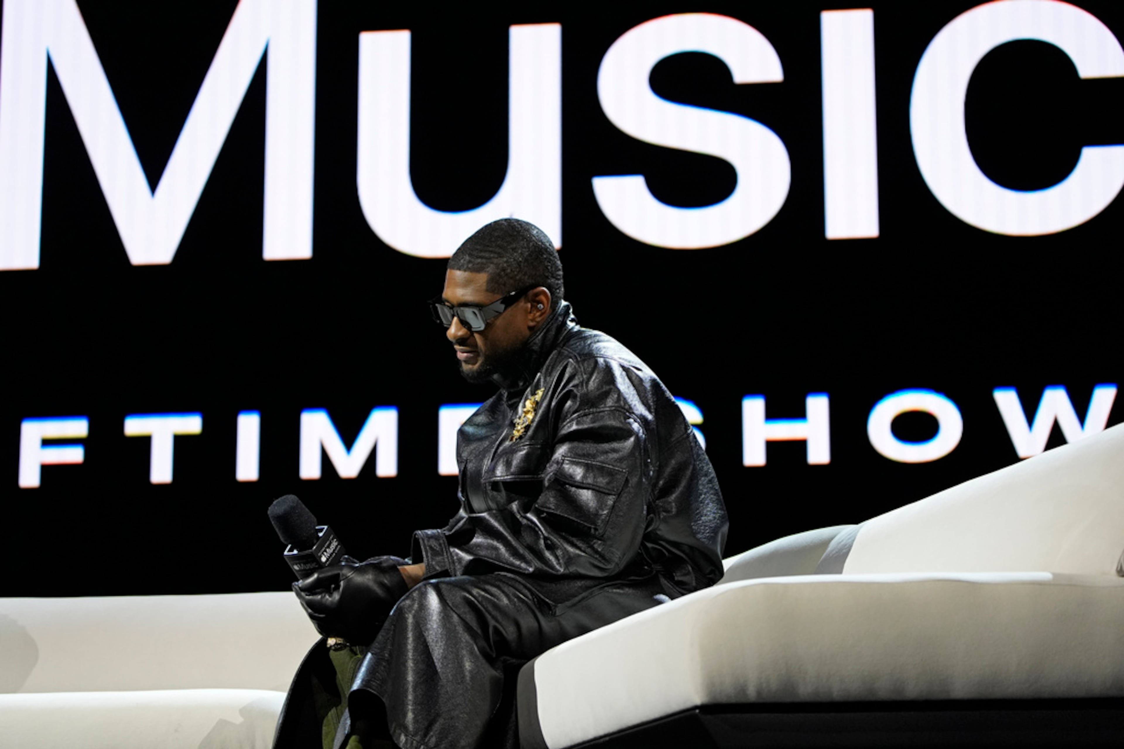 Usher listens during a news conference ahead of the Super Bowl 58 NFL football game Thursday, Feb. 8, 2024, in Las Vegas. Usher will perform during the Super Bowl halftime show. (AP Photo/John Locher)