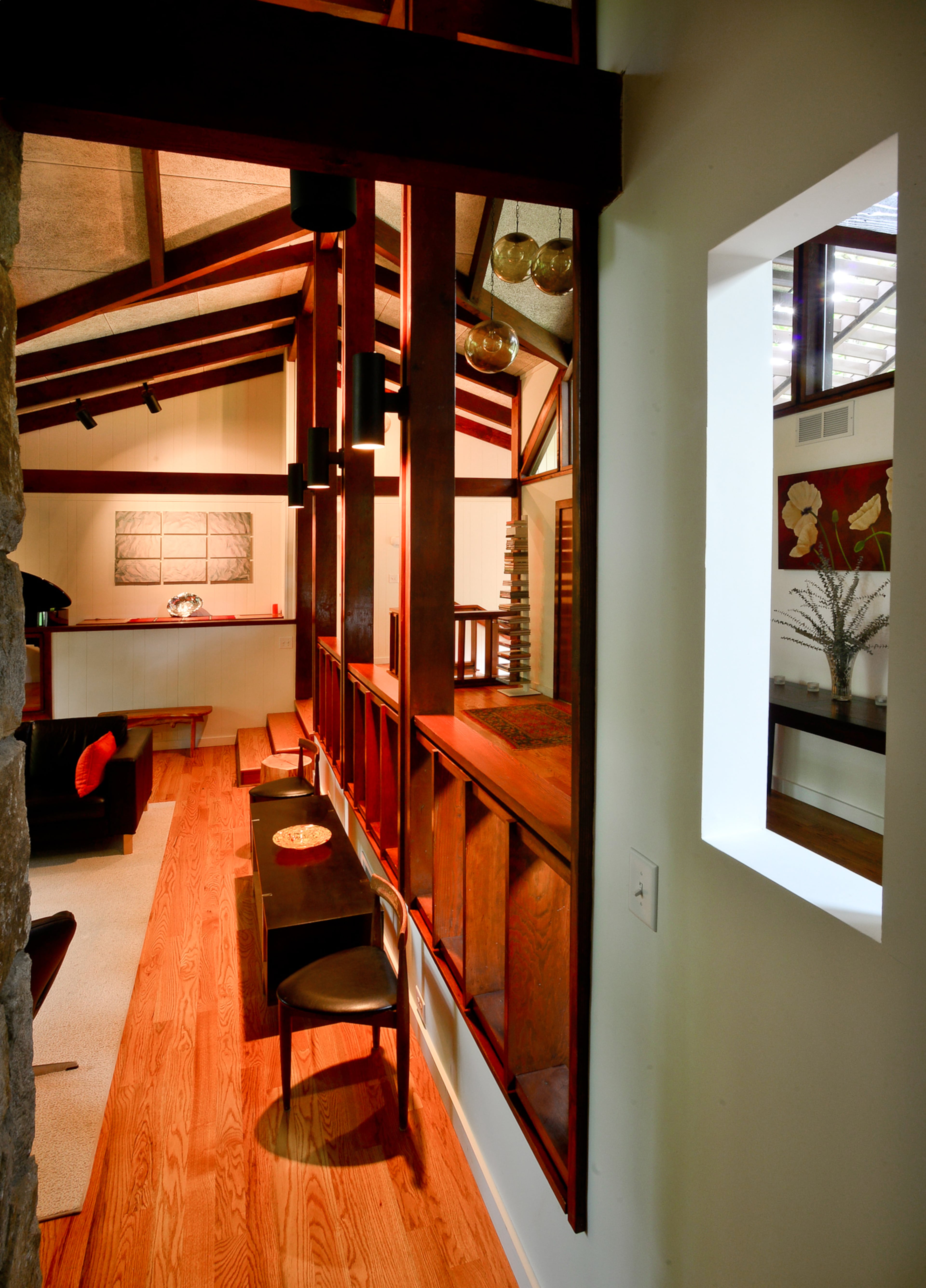 The renovations lined up a central corridor to lead from the carport to the center of the house and the bedrooms and exposed beams throughout the home.