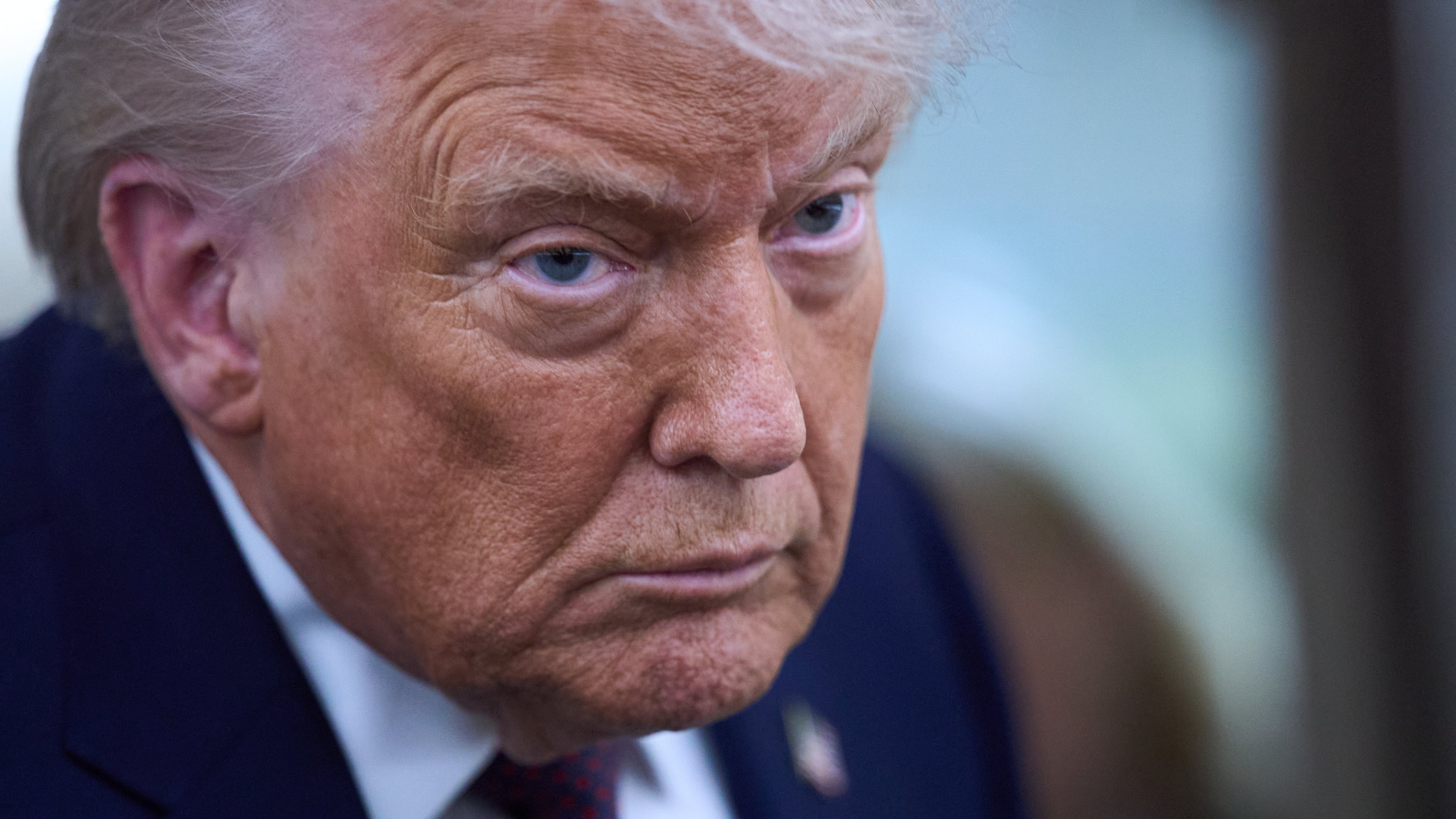 President Donald Trump speaks with reporters aboard Air Force One after leaving the World Economic Forum in Davos for Washington, Thursday, Jan. 22, 2026. (AP Photo/Evan Vucci)