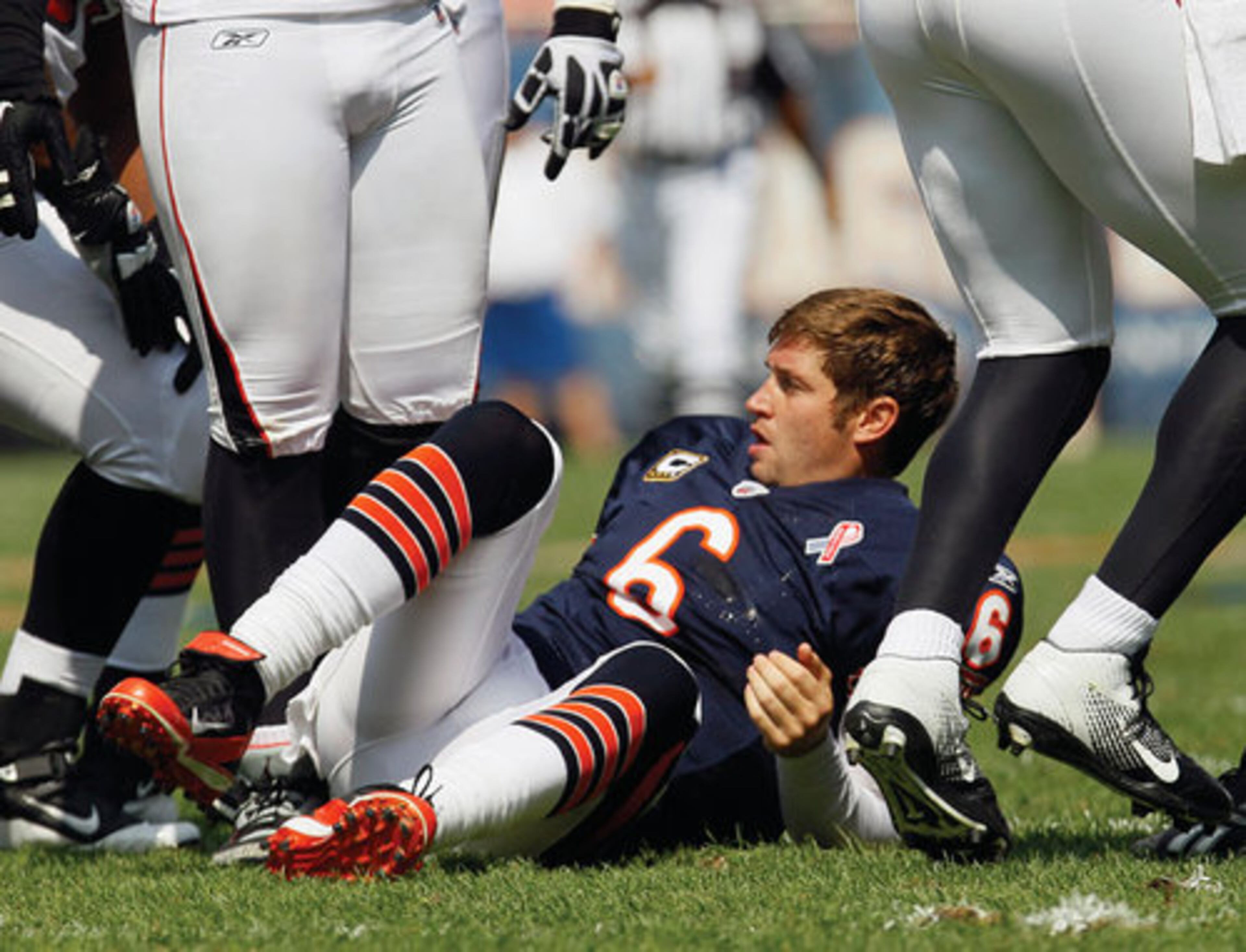 Bears quarterback Jay Cutler (6) sits on the field after being sacked by Atlanta Falcons' John Abraham in the first half of an NFL football game in Chicago.