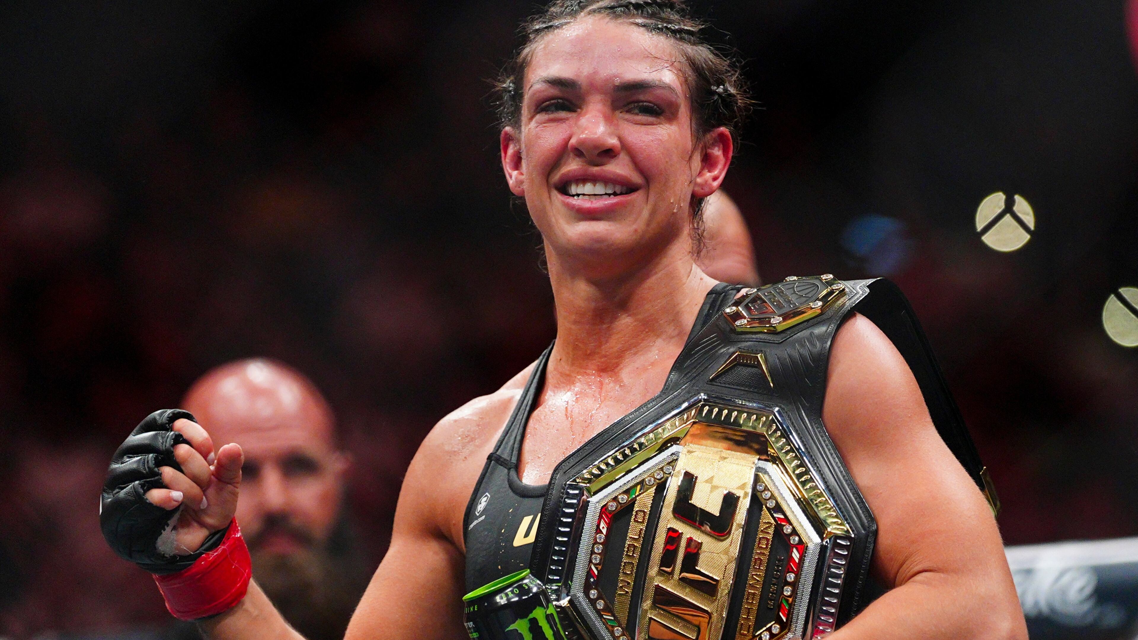 Mackenzie Dern celebrates after a women's strawweight title fight against Gillian Robertson at the UFC 330 mixed martial arts event Saturday, Aug. 15, 2026, in Philadelphia. (AP Photo/Derik Hamilton)