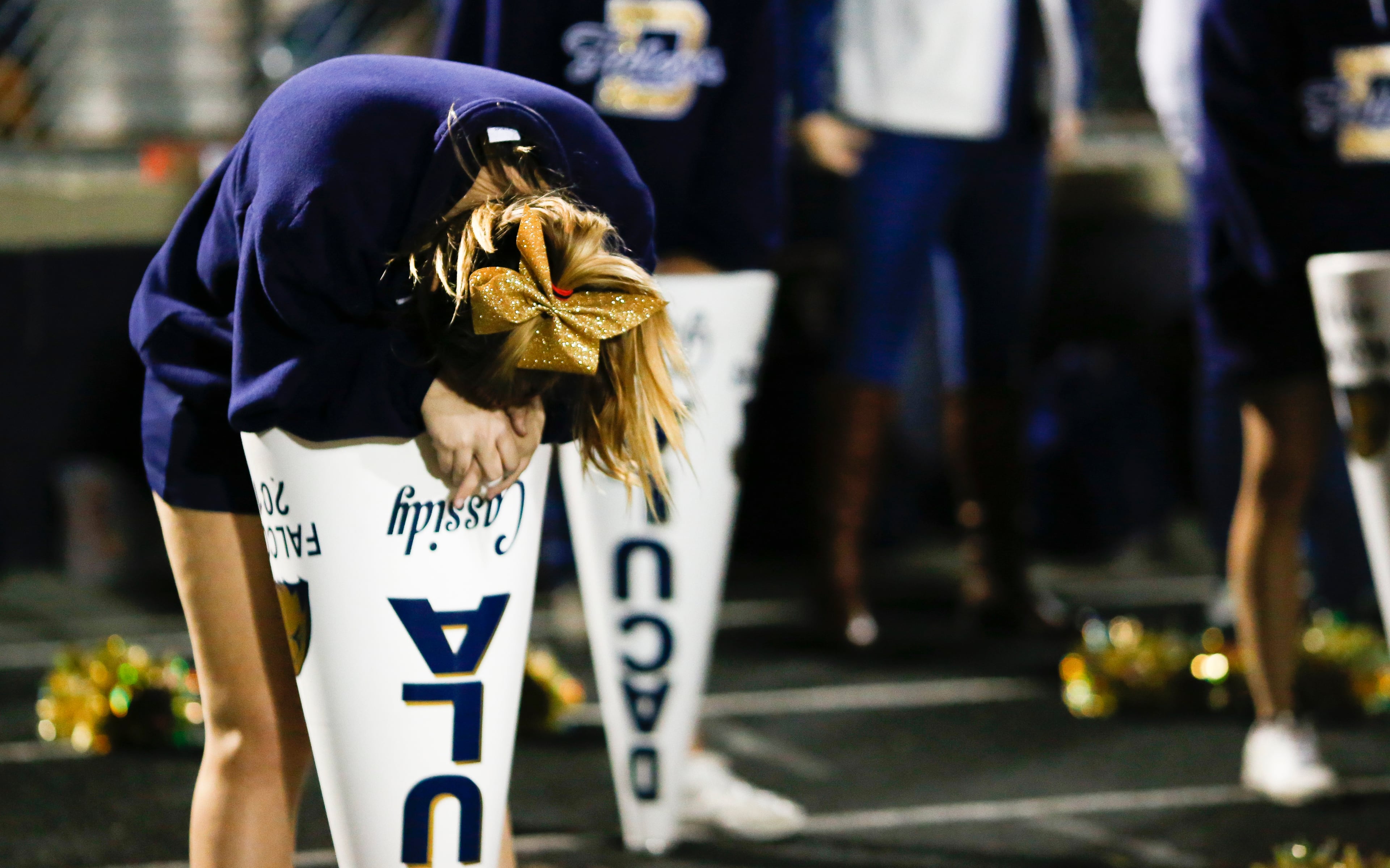A Dacula cheerleader hangs her head over her megaphone as hope fades for her team during the second half of Friday's game against Northside Warner Robins. (Casey Sykes/Special)