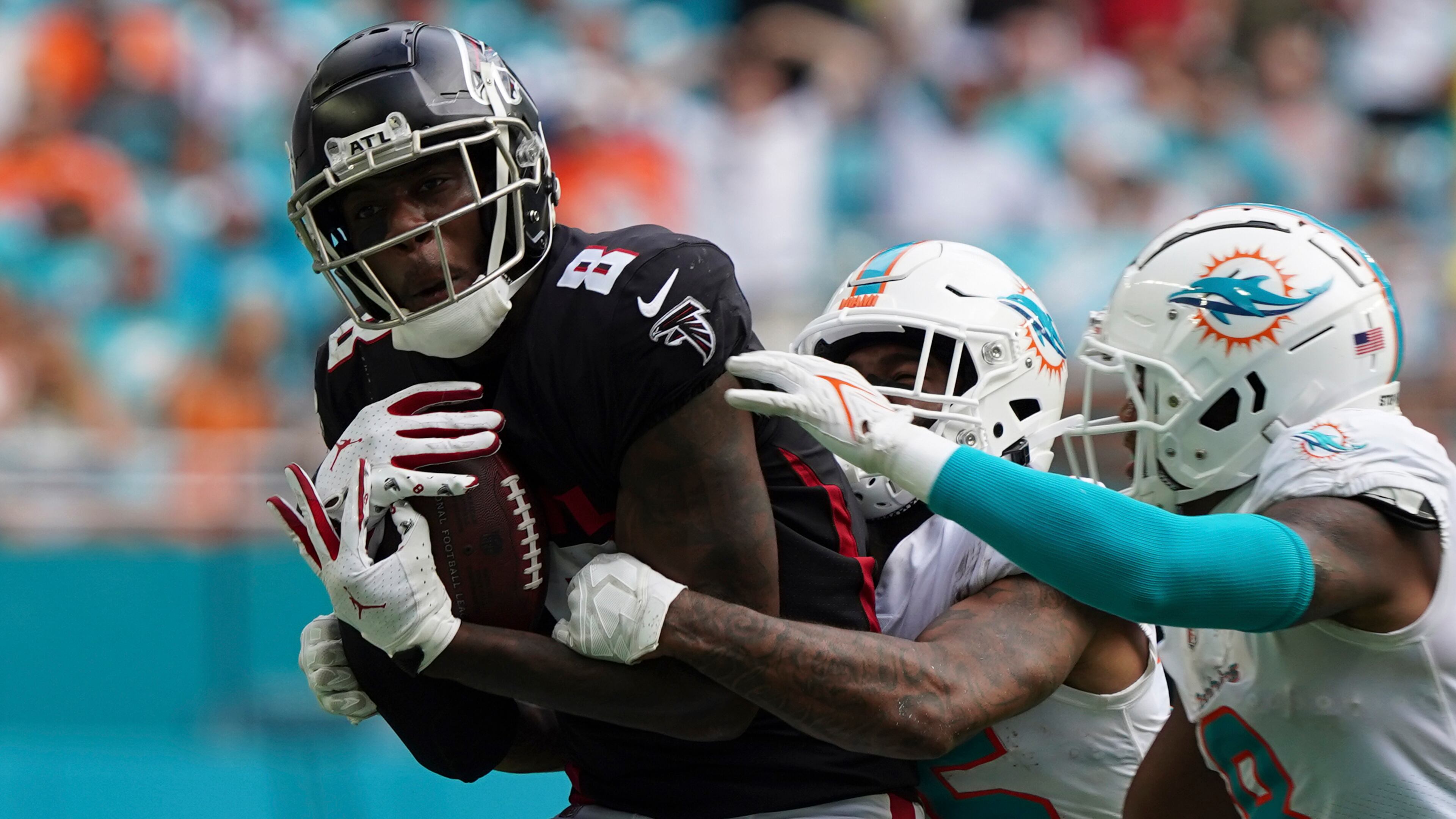 Falcons tight end Kyle Pitts (8) makes a catch, defended by Miami Dolphins cornerback Xavien Howard (25) and Miami Dolphins free safety Jevon Holland (8) late in the second half Sunday, Oct. 24, 2021, in Miami Gardens, Fla. (Hans Deryk/AP)
