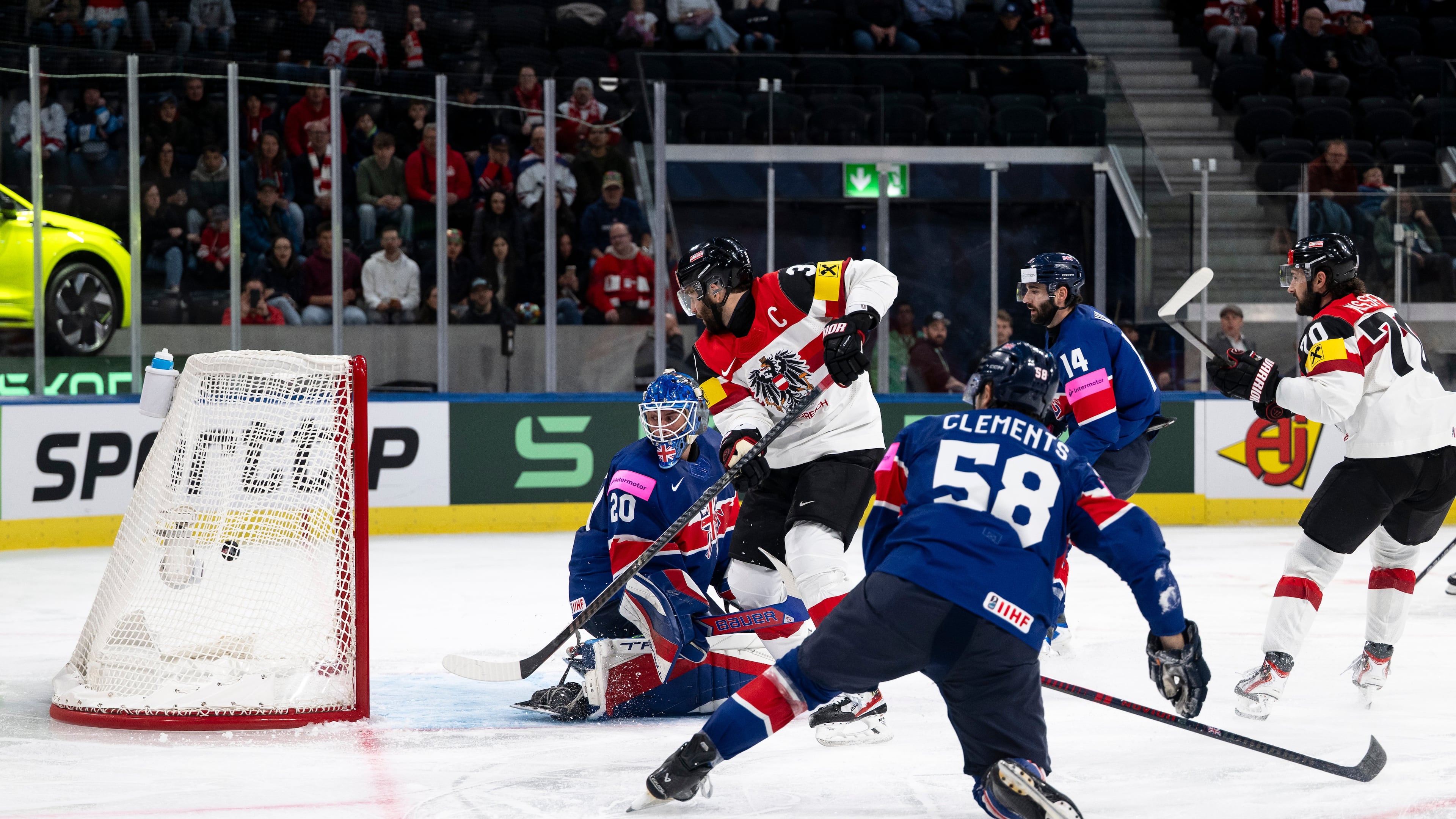 Austria's Peter Schneider, 2nd from left, scores his side's fourth goal past Britain's goaltender Mat Robson, during the 2026 IIHF Men's Ice Hockey World Championship preliminary round group A game between Britain and Austria, in Zurich, Switzerland, Saturday, May 16, 2026. (Andreas Becker/Keystone via AP)