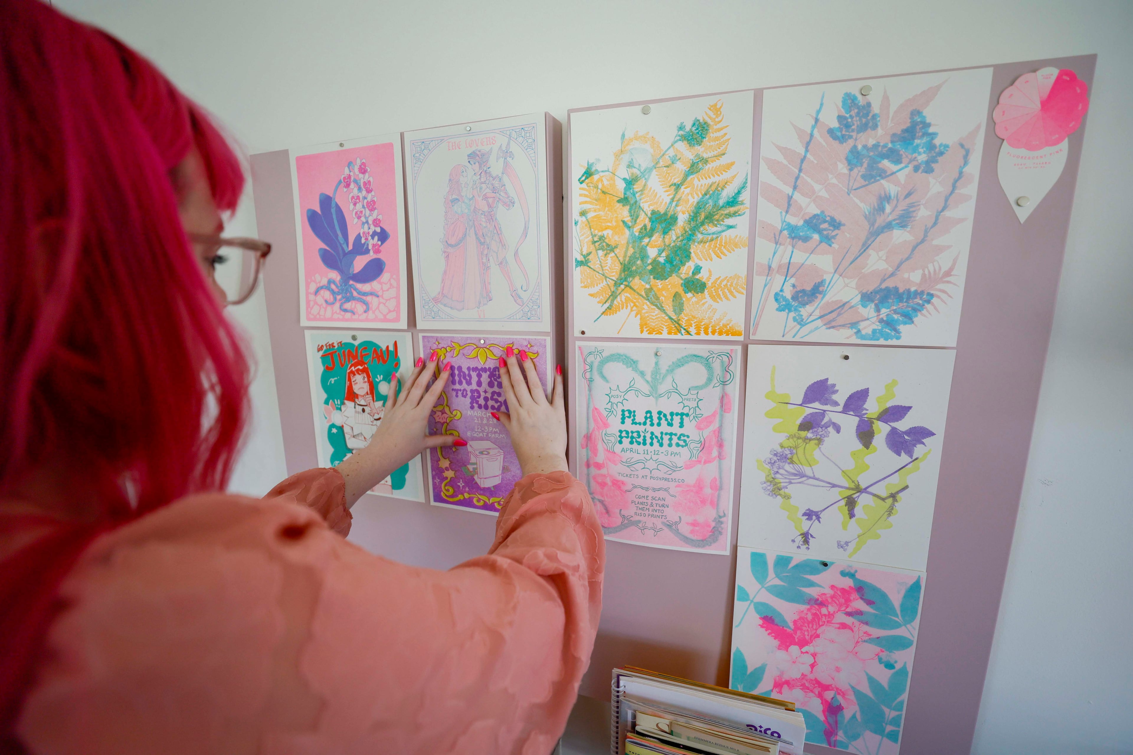 Richardson displays prints from the last Risograph workshop at Posy Press. Since December, Posy Press has been hosting Riso workshops for beginners and advanced students to explore various techniques that produce vibrant prints. (Miguel Martinez/AJC)