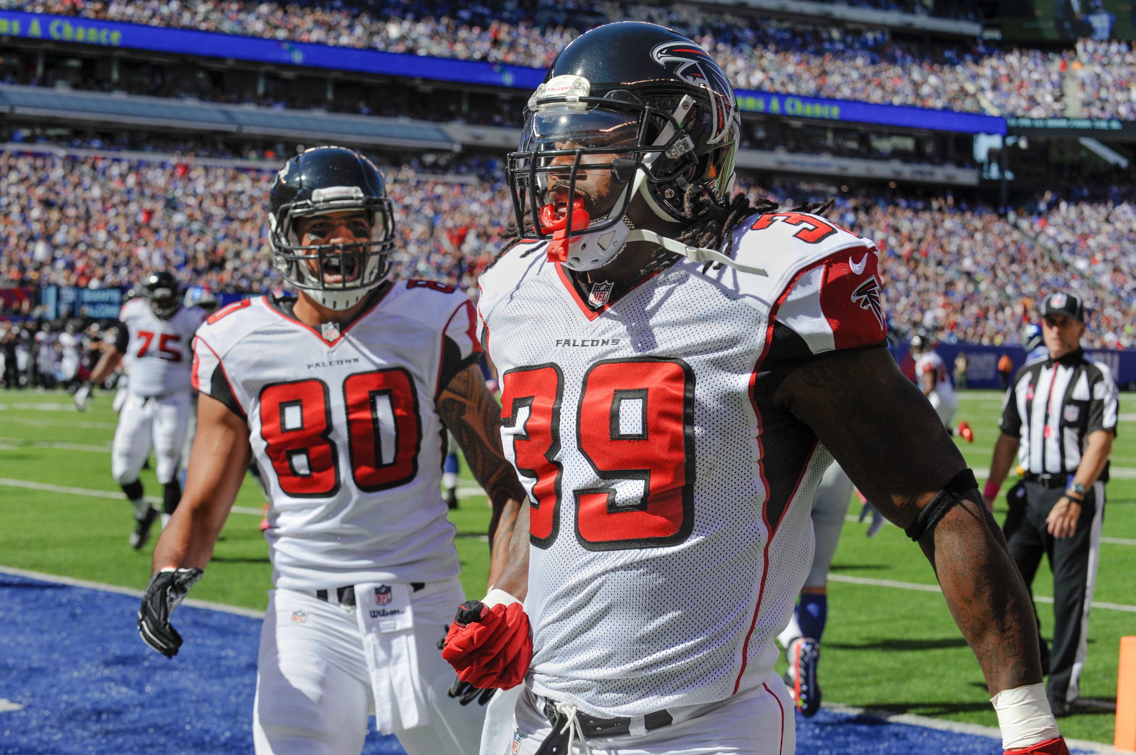 Atlanta Falcons running back Steven Jackson (39) celebrates with Levine Toilolo (80) after scoring a touchdown against the New York Giants during the first half of an NFL football game, Sunday, Oct. 5, 2014, in East Rutherford, N.J. (AP Photo/Bill Kostroun)